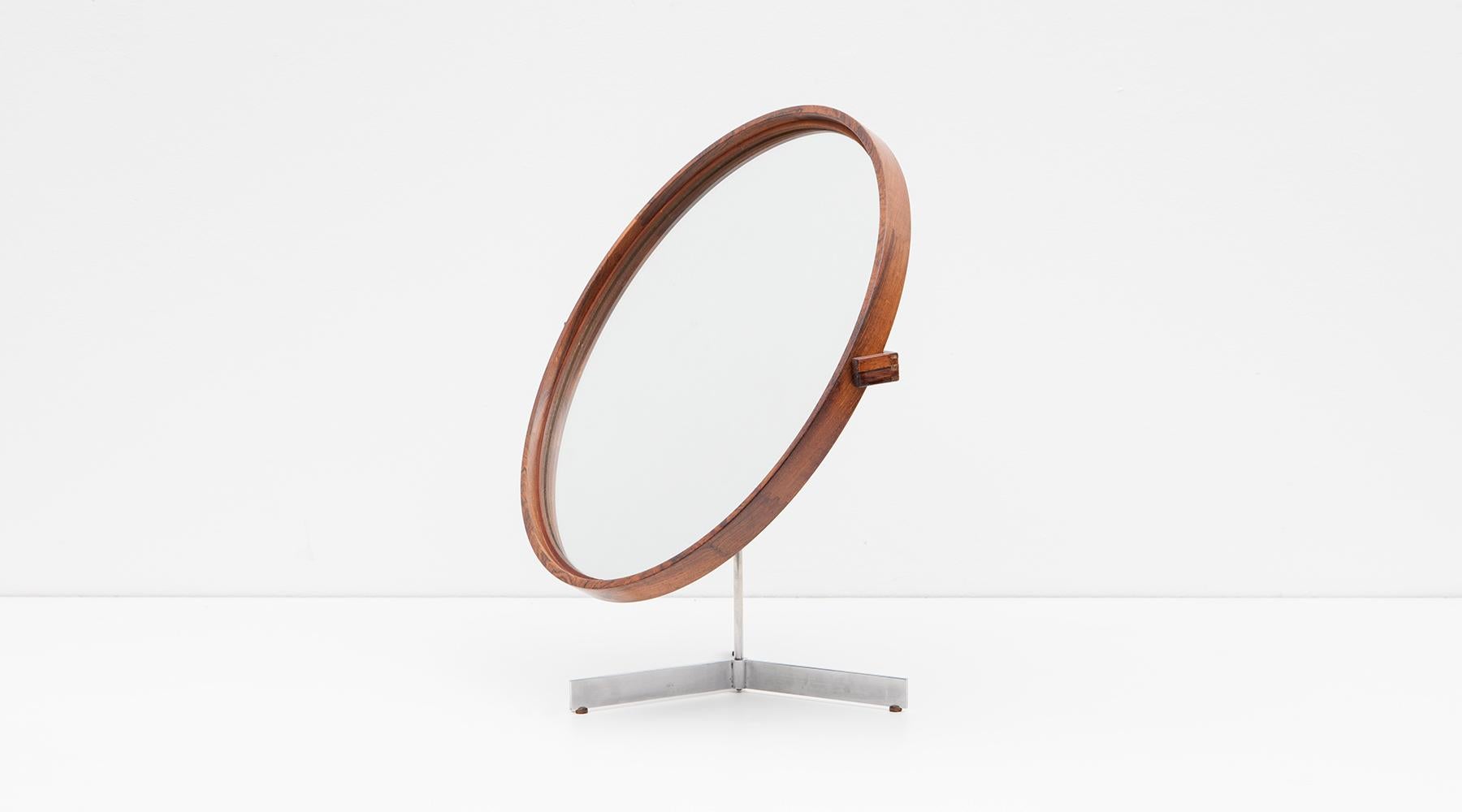 Mirror in rosewood by Uno and Östen Kristiansson, Sweden, 1965.

Breathtaking round mirror framed in rosewood standing modestly on a three-legged metal frame. The mirror can be rotated and tilted backwards. Designed by famous Swedish brothers Uno