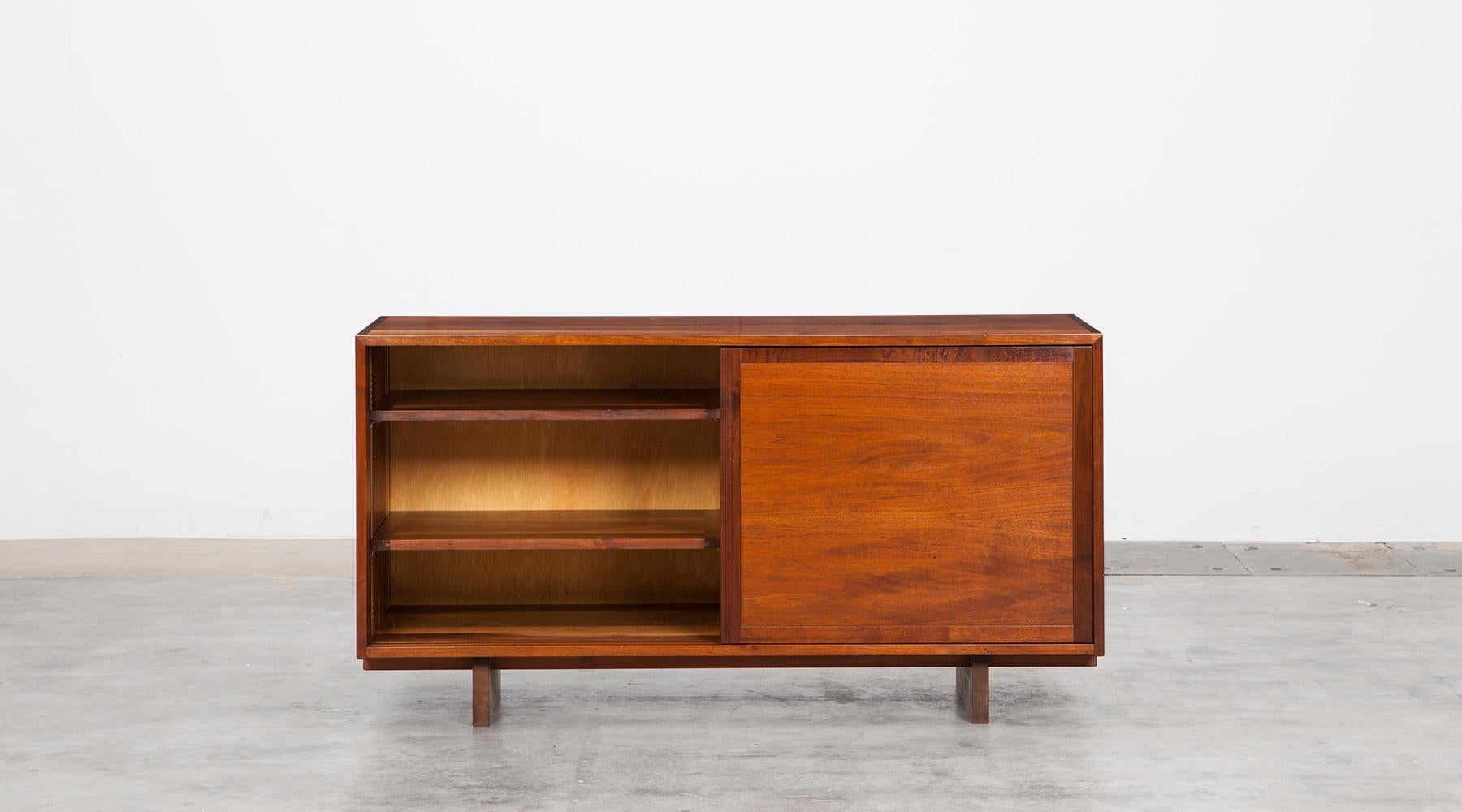 Handcraft sideboard in walnut, George Nakashima, 1962, USA

This handcrafted sideboard by George Nakashima comes with two sliding doors which conceal four drawers on one side and two shelves on the other side. This pieces made out of walnut comes in