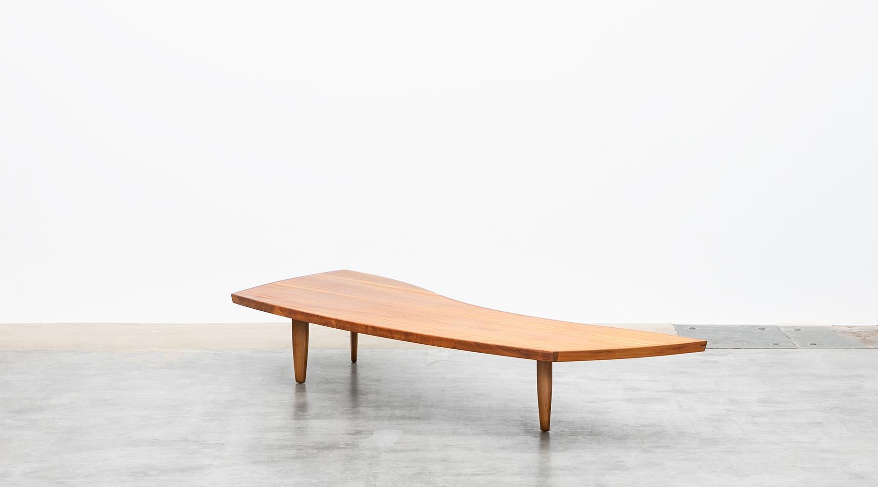Coffee table, walnut veneer, George Nakashima, USA, 1960.

The handcrafted coffee table comes with a walnut veneer top and is supported by four tapered dowel legs. The table is designed by famous American George Nakashima and can also be used as a