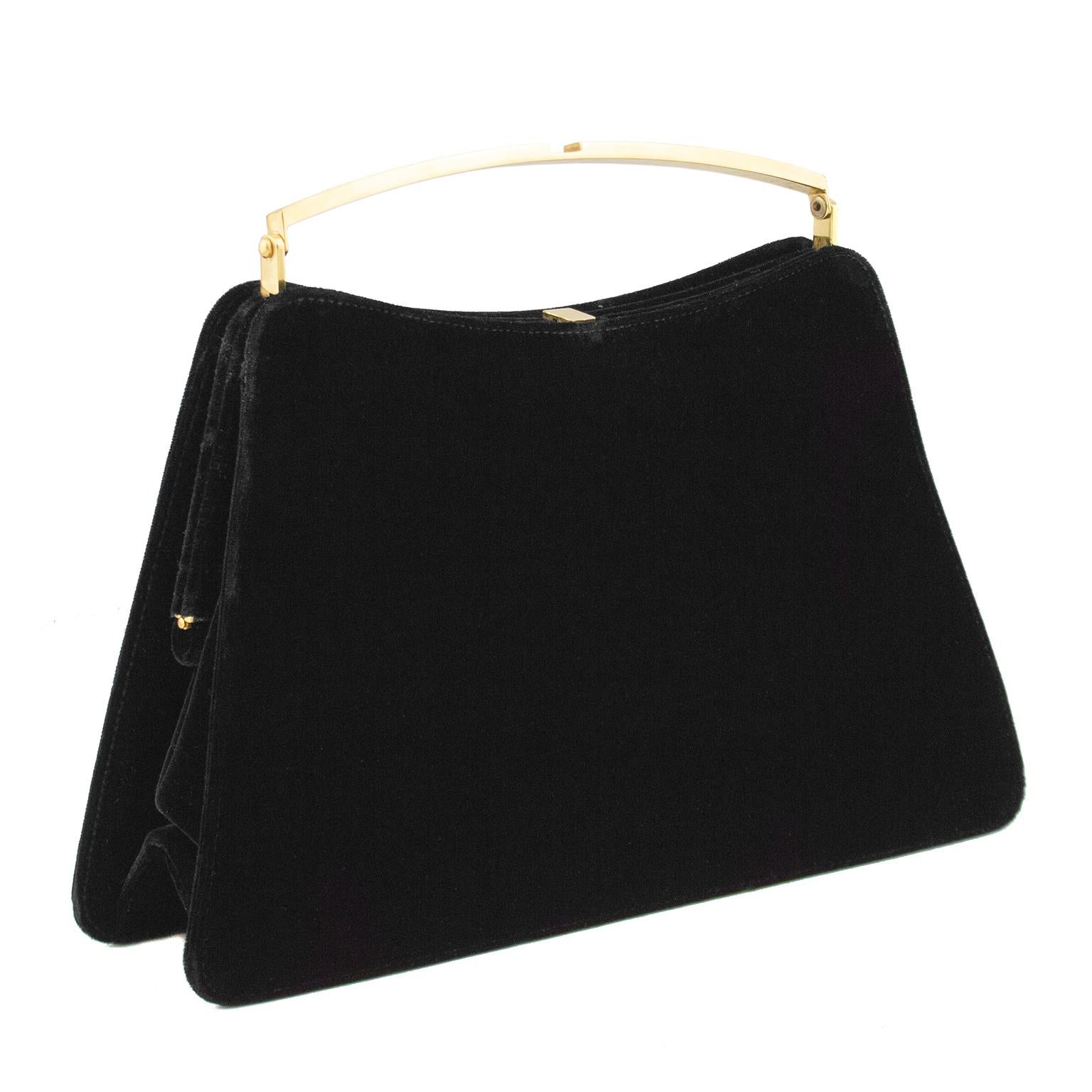 Beautiful 1960's jet black cut velvet hard frame dinner bag. Contrasting gold tone top handle and hardware. Black branded lining and interior slit pocket with zipper. Brand markings on all interior gold tone hardware. Great size for an