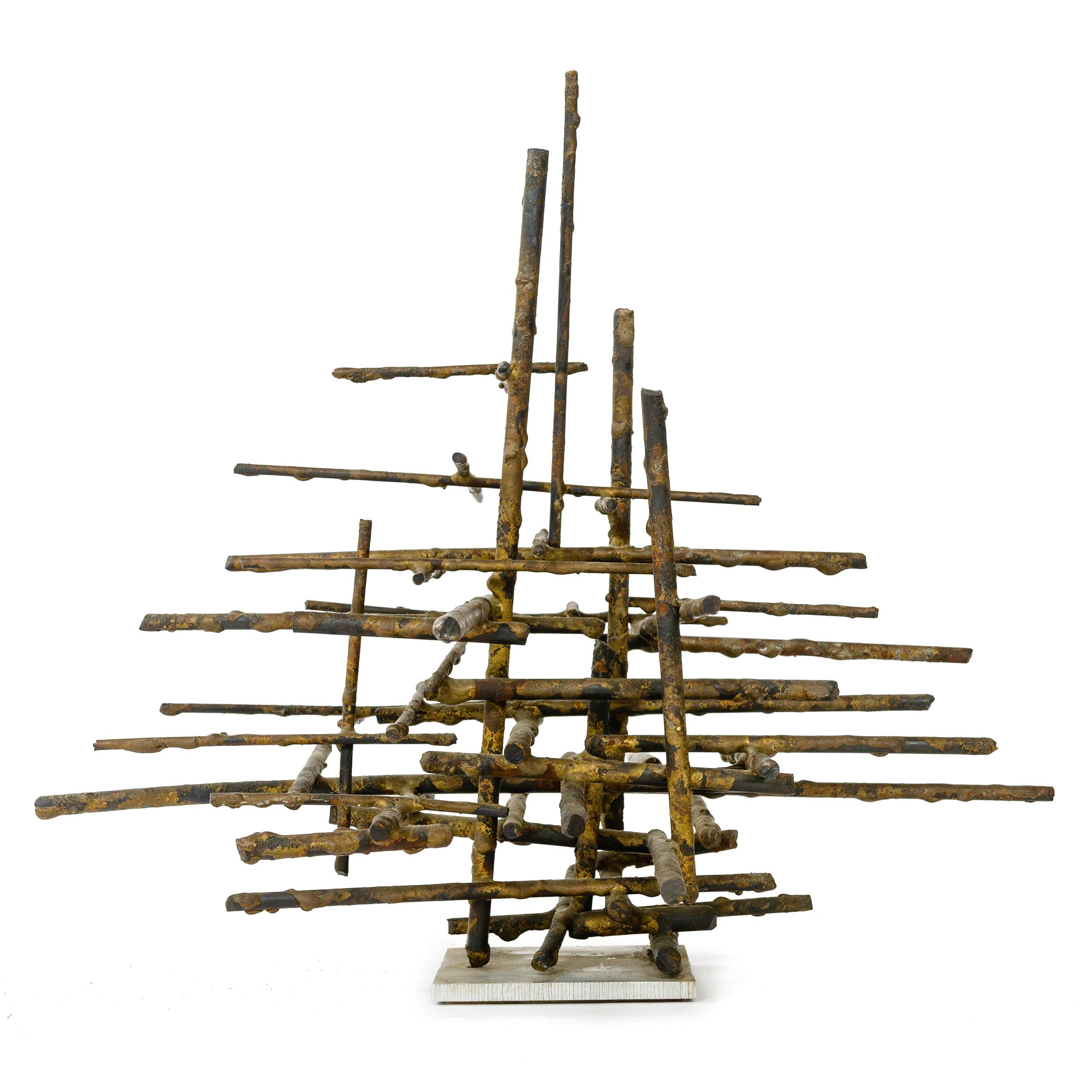 Brutalist tabletop sculpture being a linear assemblage of bronze twig like rods of varying lengths stacked on a square aluminum base. Letters 'HF' and '64' etched in to the base in a modern sans serif font.
