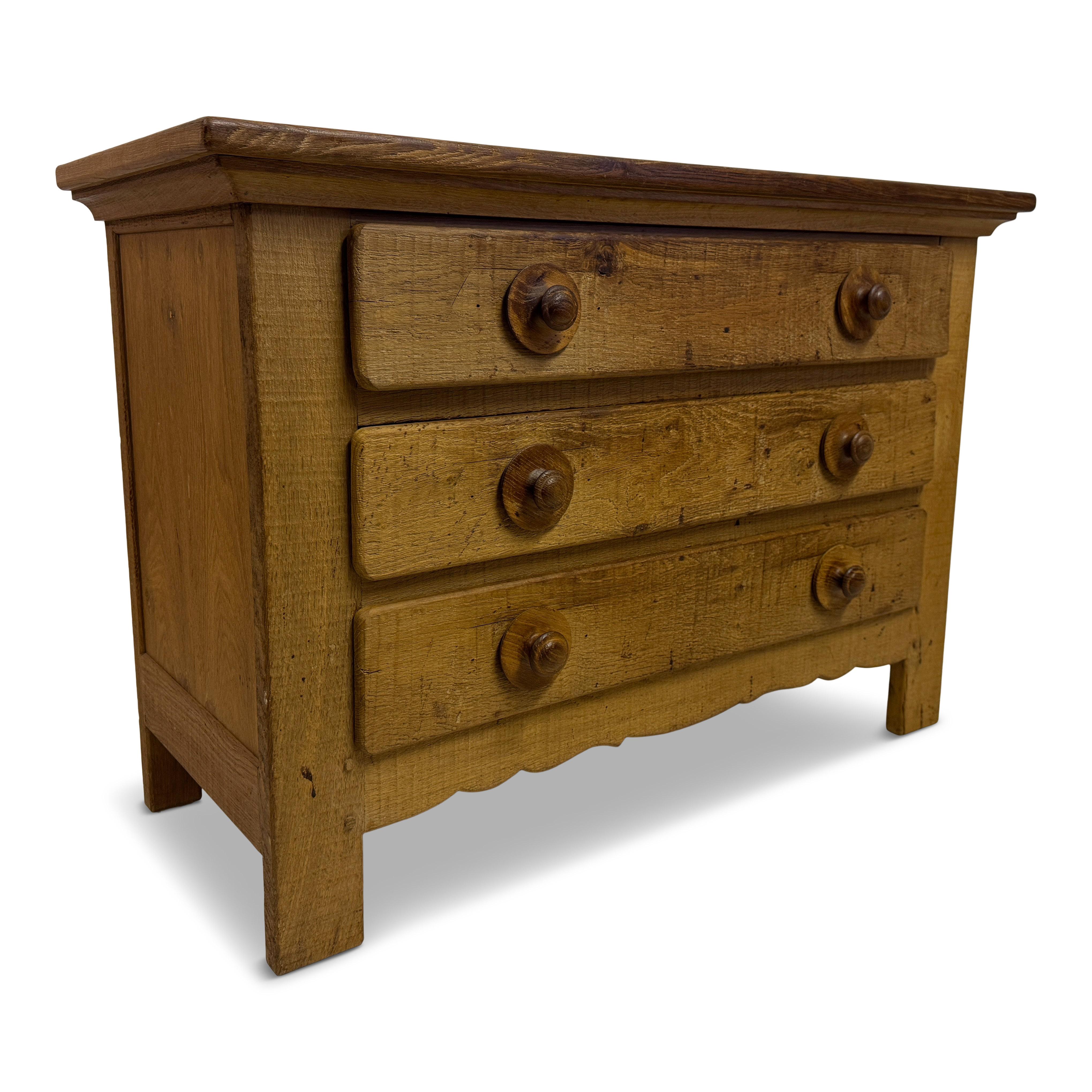 1960s Brutalist Oak Chest of Drawers

A rugged and quietly sculptural oak chest of drawers from the 1960s, exemplifying the Brutalist tradition through its raw materiality and unembellished form. Crafted in solid, rough-sawn oak, the piece displays