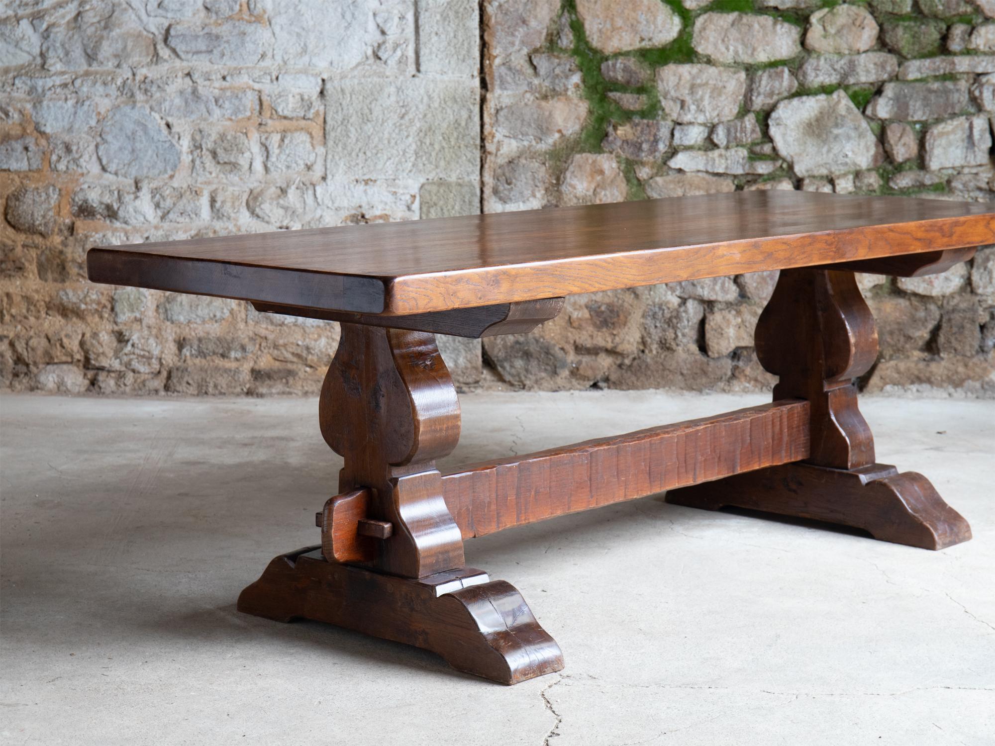 A brutalist oak monastic style dining table. French, c. 1960s.

A very heavy and solid piece. Nominal age-related wear.

76.5 x 221.5 x 81 cm (30.1 x 87.2 x 31.9 