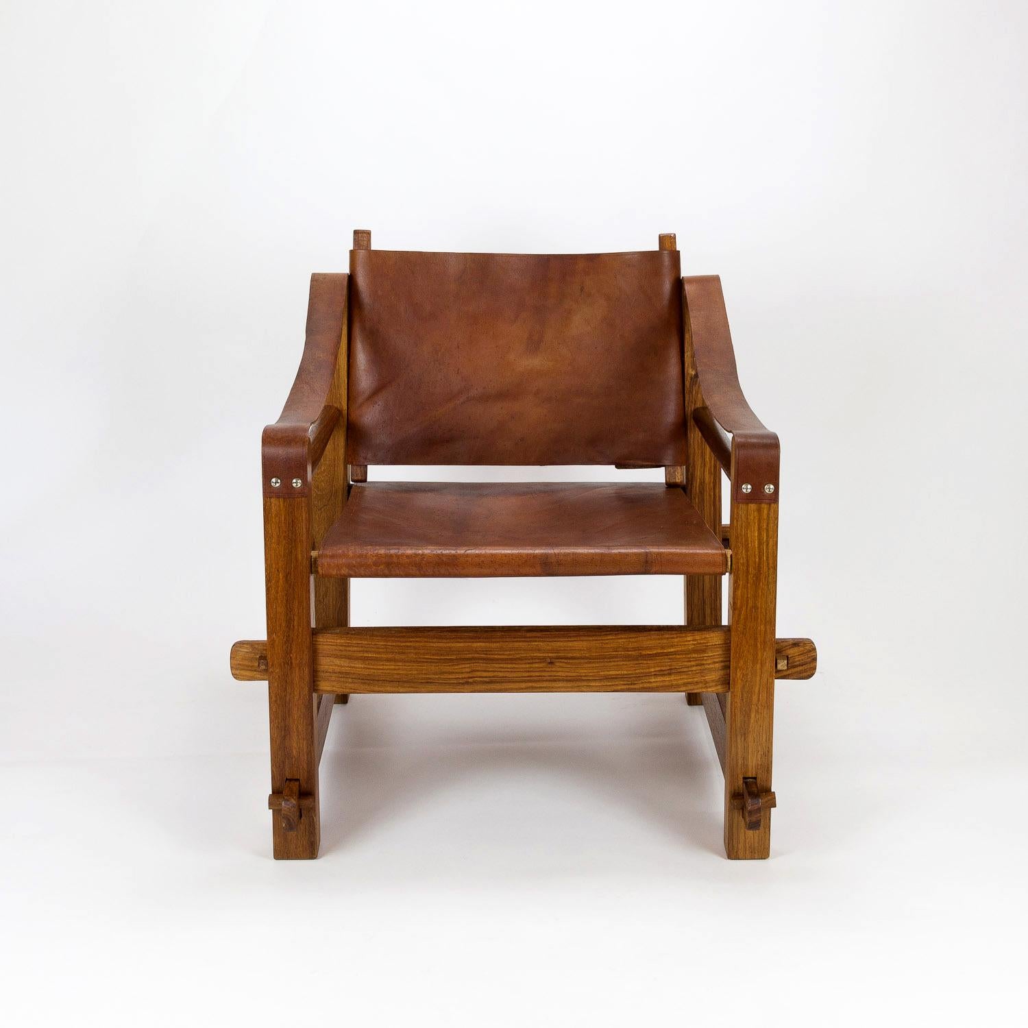 Handmade brutalist safari chair in solid teak and leather. Anonymous. 1960s.

 
