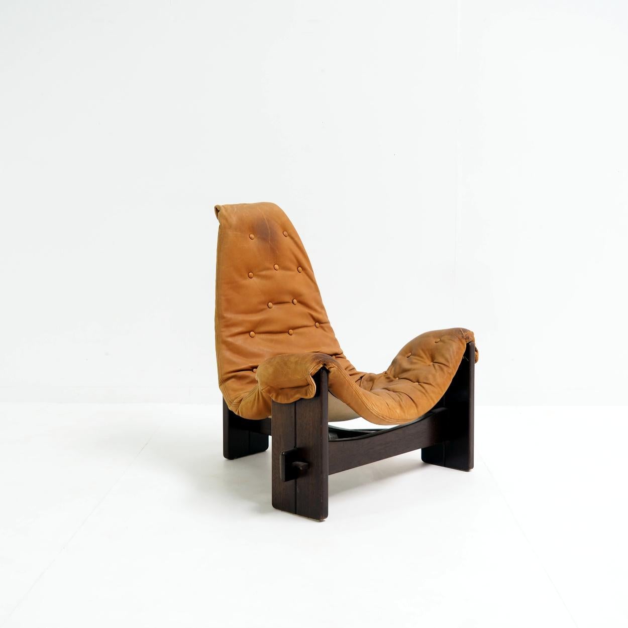 Very special lounge chair of Brazilian origin.

This chair, with its brutalist and beautiful jungle look, is handmade using only natural materials and earthy colors. No screws used. The canvas and leather is attached to the base with pins and can