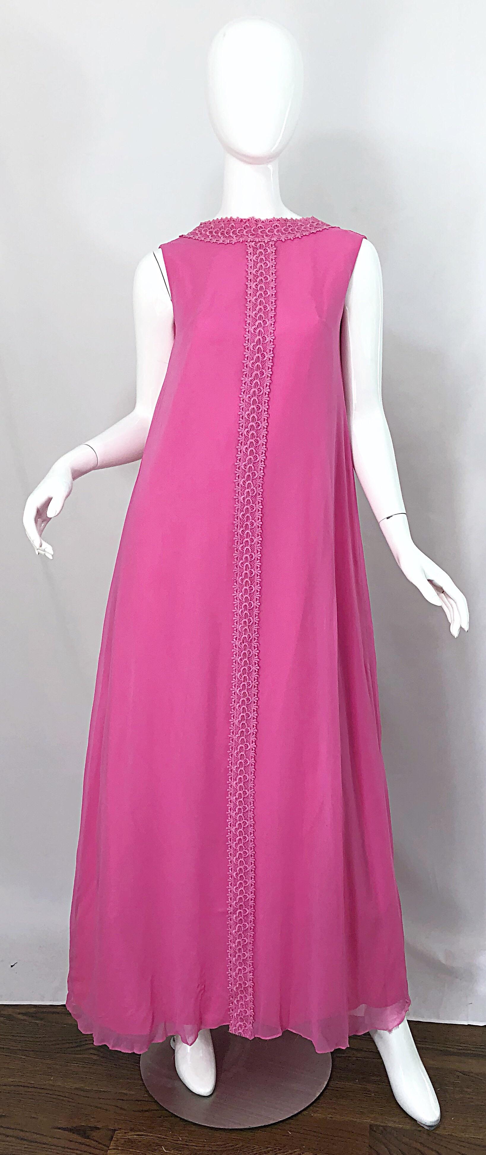 Chic 1960s demi couture bubblegum pink silk chiffon high neck gown! Features hand embroidery up the center front, collar, and back neck. Low cut back features a bow with full metal zipper up the back and hook-and-eye closure. Hidden snaps on the bow