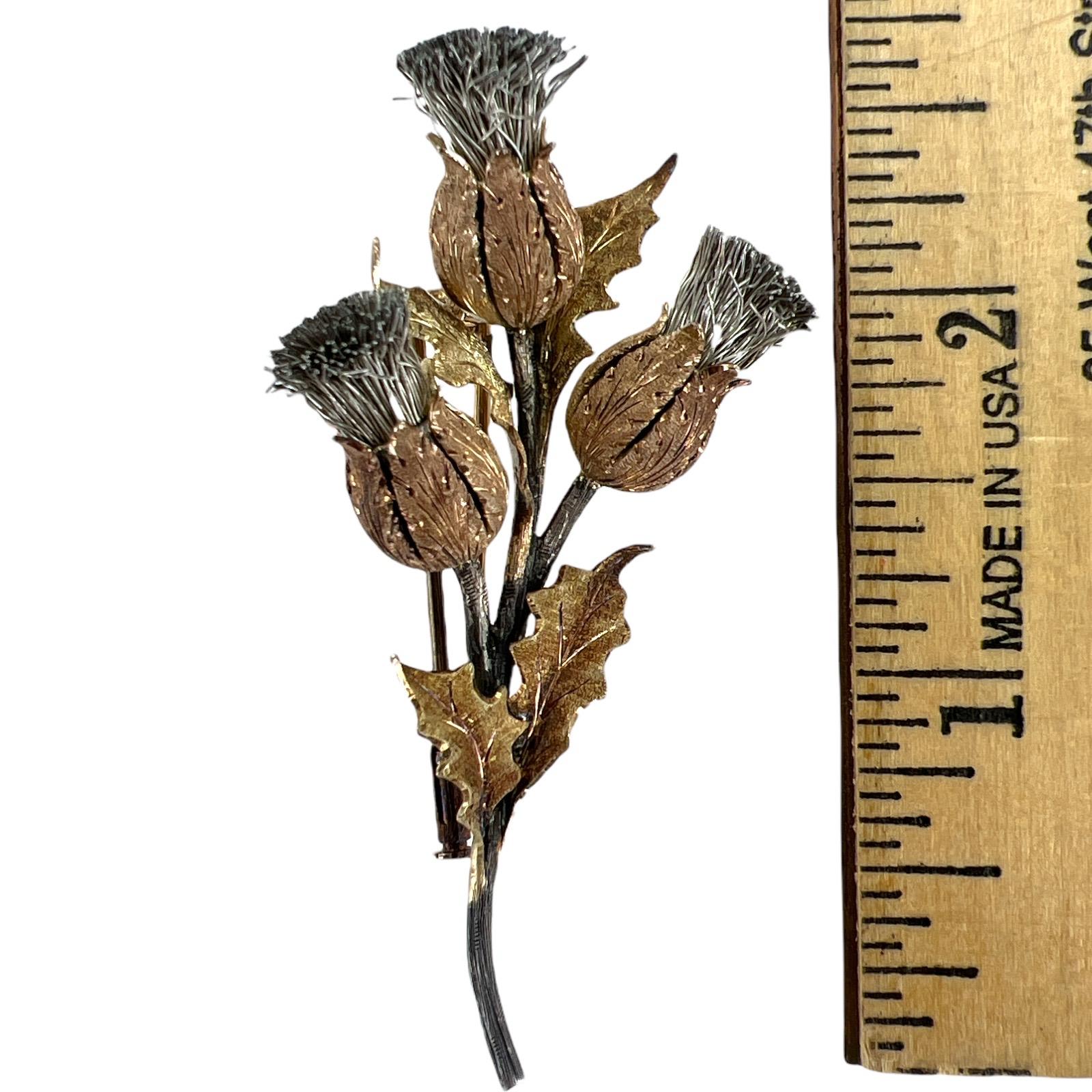 Beautiful creation by Mario Buccellati circa 1960's. The thistle floral brooch is crafted in 18 karat yellow gold and sterling silver, and measures approximately 1.50 x 2.75 inches. Signed M. Buccellati Italy. 