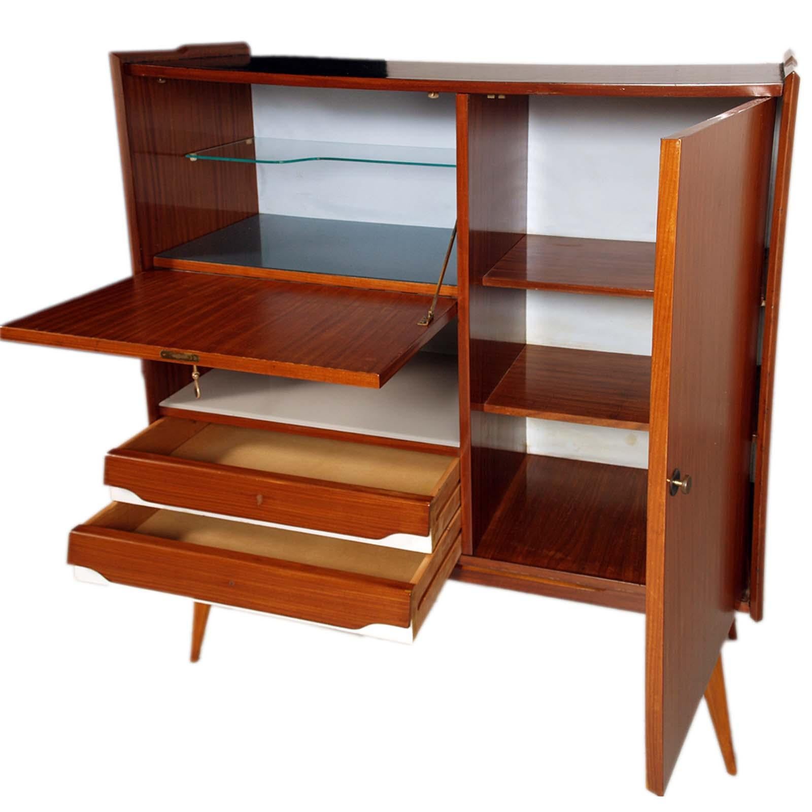 1960s Buffet dry bar by Consorzio Esposizione Mobile di Cantù,  attributed to Ico & Luisa Parisi , in Tuscan Rigatino Walnut, with internal inserts (tops) in crystal and Formica.
Black silkscreen, Giorgio Morandi style, flap panel on the front
All