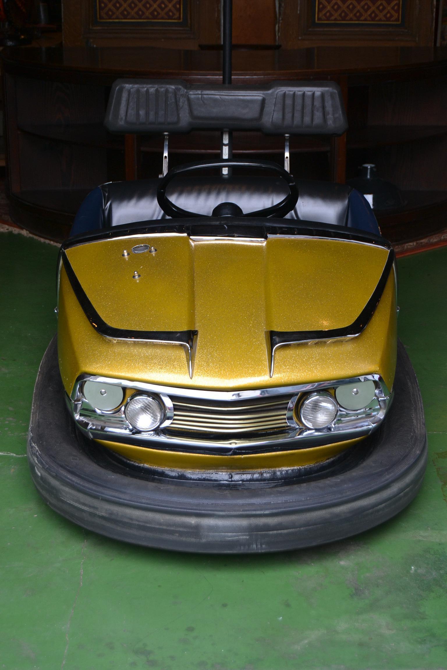 1960s Bumper Car by Reverchon , France. 
This Dodgem Car - Bumper Vehicle is still in very very beautiful condition. 
As well the paint as all the chrome are great. 
The colour is gold - dark yellow depending on the light he's standing in . 
The