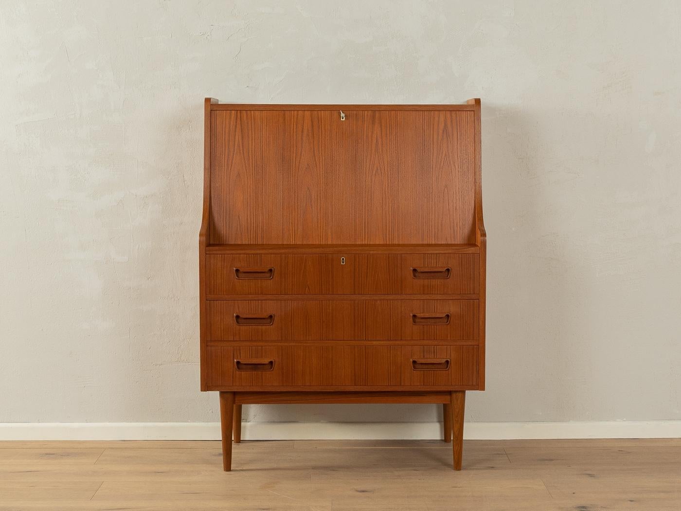 Classic secretary from the 1960s by Gunnar Nielsen for Tibergaard. High-quality corpus in teak veneer with a hinged work surface, four interior drawers, one compartments, three drawers and cigar shaped feet.

Quality Features:

    very good
