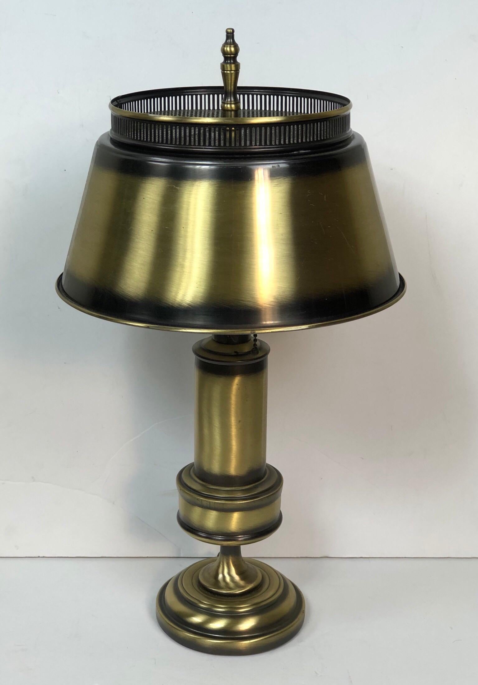 Vintage 1960s burnished brass table or desk lamp with a round metal shade. The lamp is wired for the US and in working condition. The lamp takes two bulbs and is unmarked.