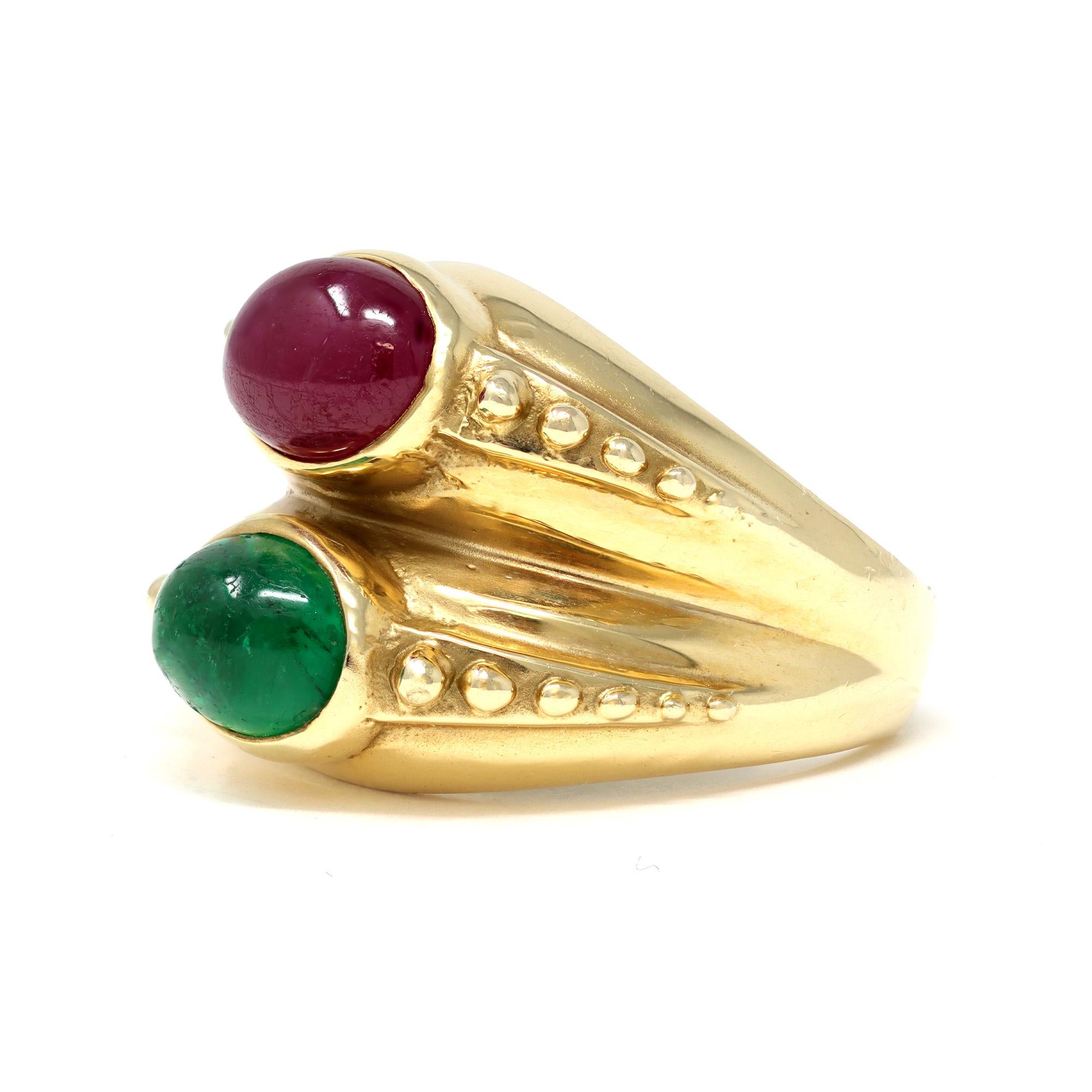 The vintage double stone ring is circa 1960. It is styled in 18 karat yellow gold. The ring presents 2 matched in size oval cabochon ruby and emerald. The emerald has an estimated weight of 2.50 carats with a minor inclusion to the surface. The deep