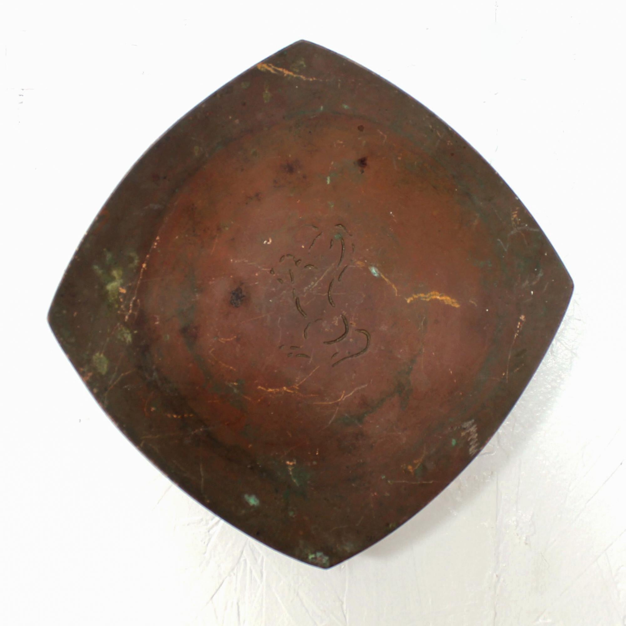 Beautiful patinated bronze tray dish or wall art designed by California Artist and Sculptor Wah Ming Chang (1917-2003). This warmly-colored work, presents in a rounded square shape featuring a simplified engraved horse design in the center.
Stamped