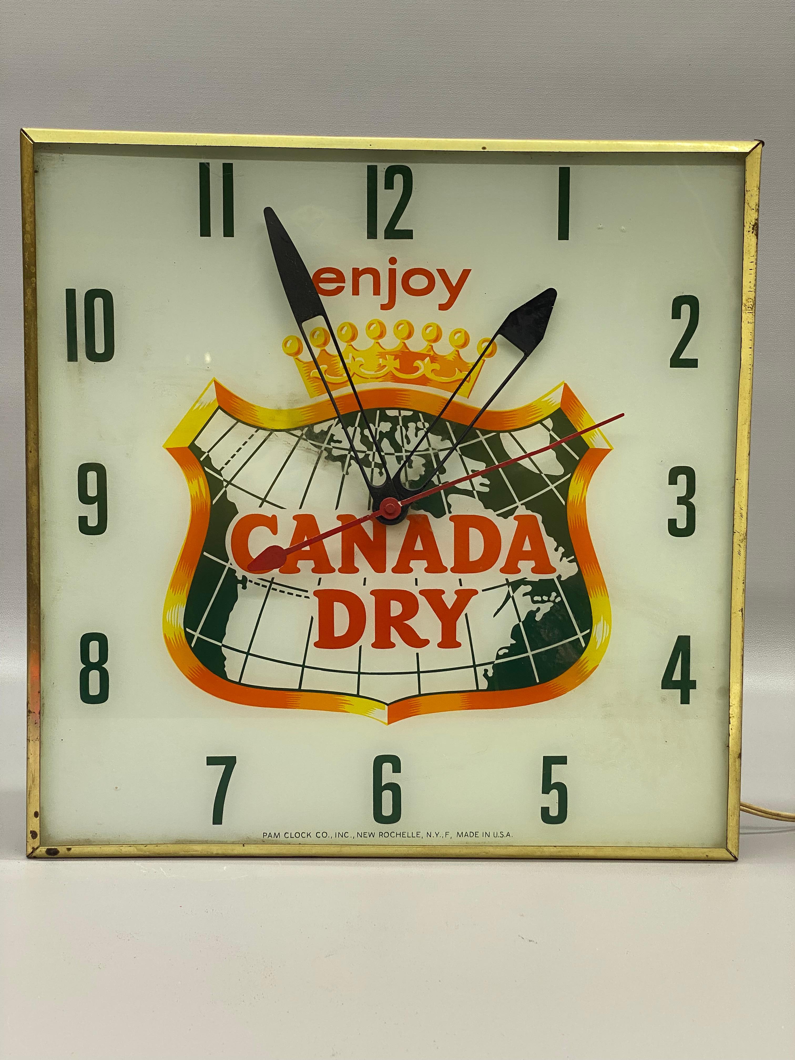 Canada Dry Ginger Ale illuminated advertising wall clock made by Pam Clock Company, New Rochelle, New York. The Pam Clock Company was famous for making all of these fun advertising clocks that adorned the walls  usually found in bars, grocery