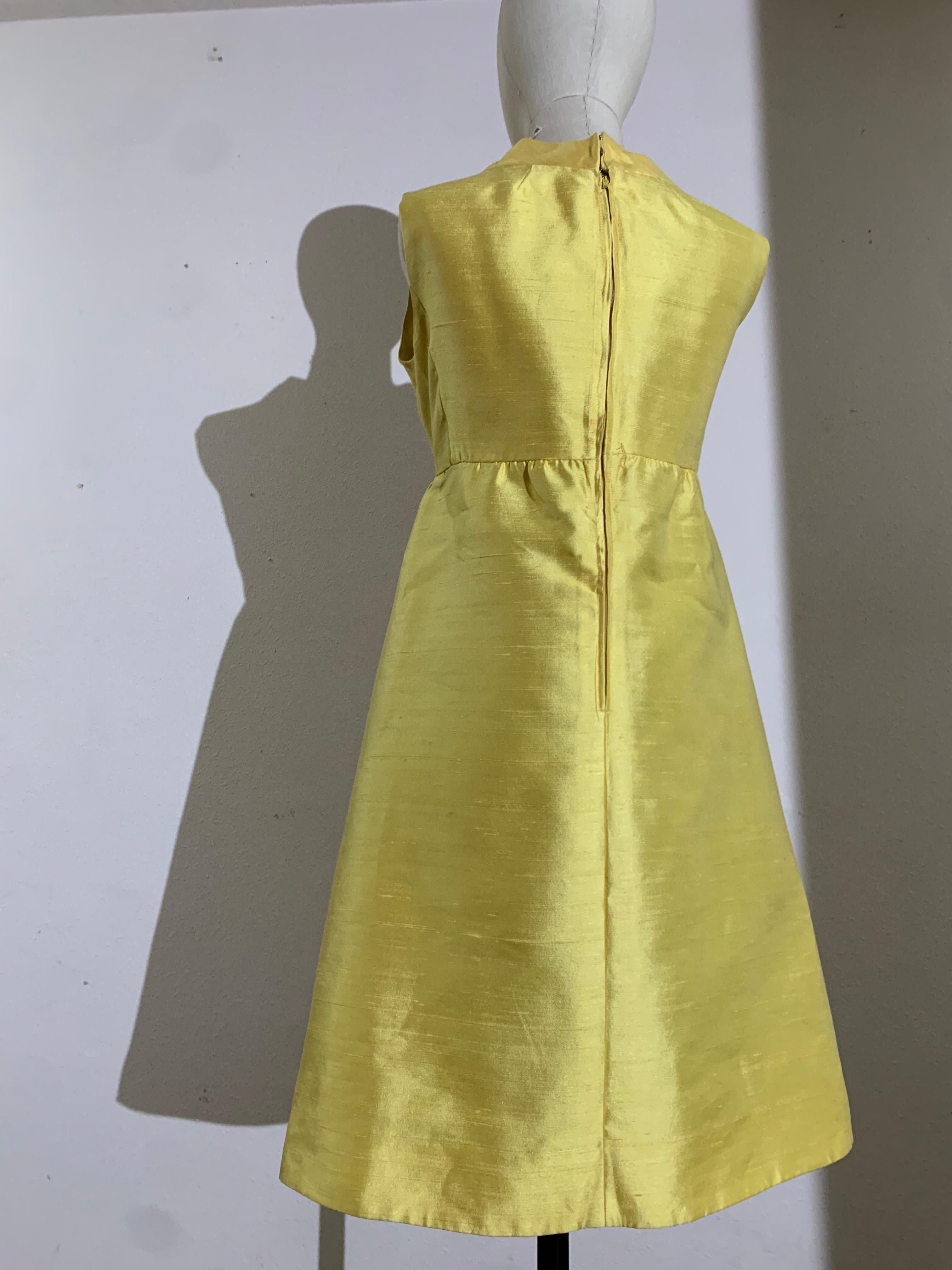 1960s Canary Yellow Silk Shantung Empire-Waist Sleeveless Cocktail Dress:  With a banded open neckline. Fitted in bust and A-line below, with side slit pockets, this beautiful and simple dress is lined and has a full, long back zipper. Designed by