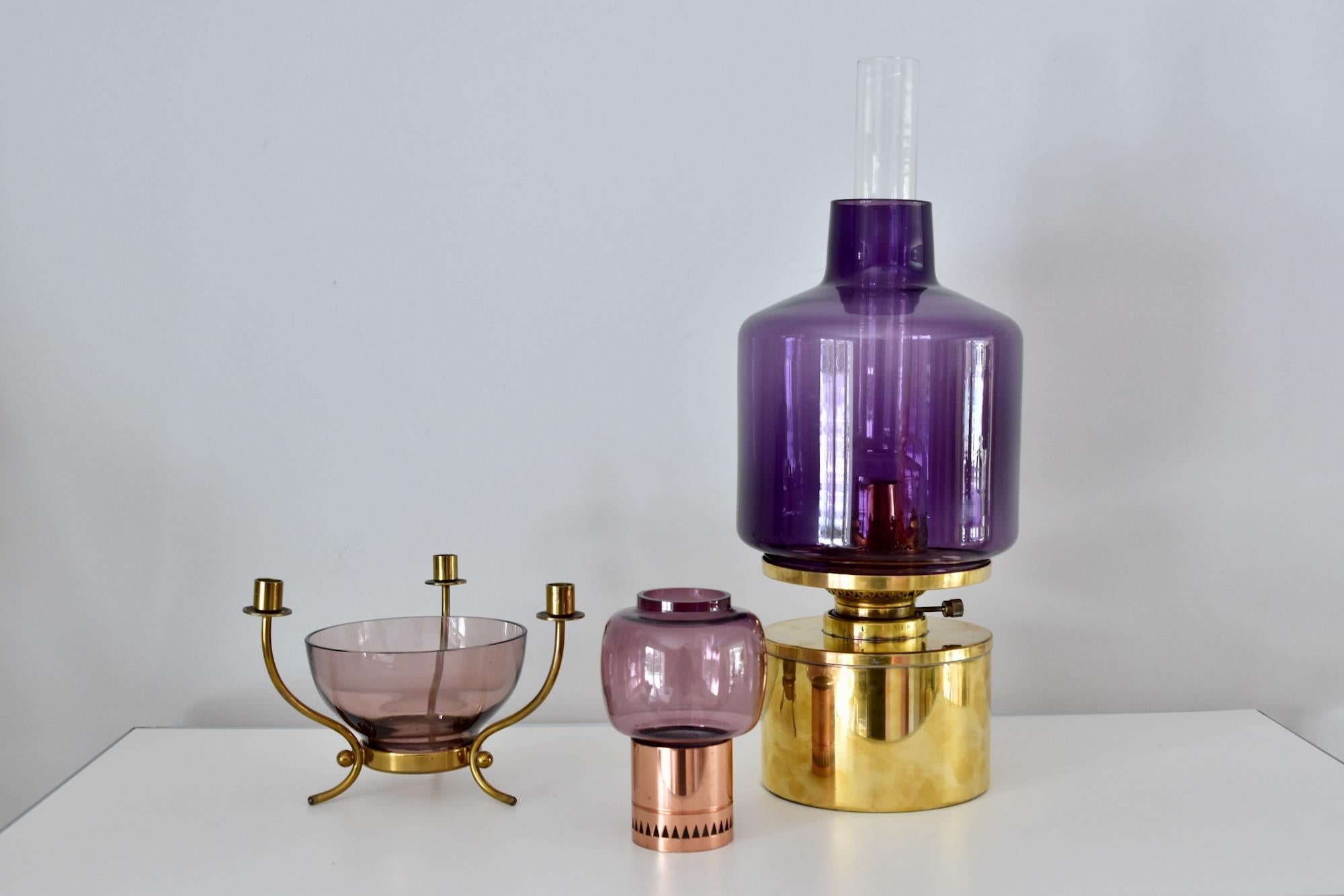 Beautiful candlesticks by Hans-Agne Jakobsson.
Measurements: diameter 8cm, height 12cm
Purple glass and copper base.
Very nice condition. Price for one candleholder.

 