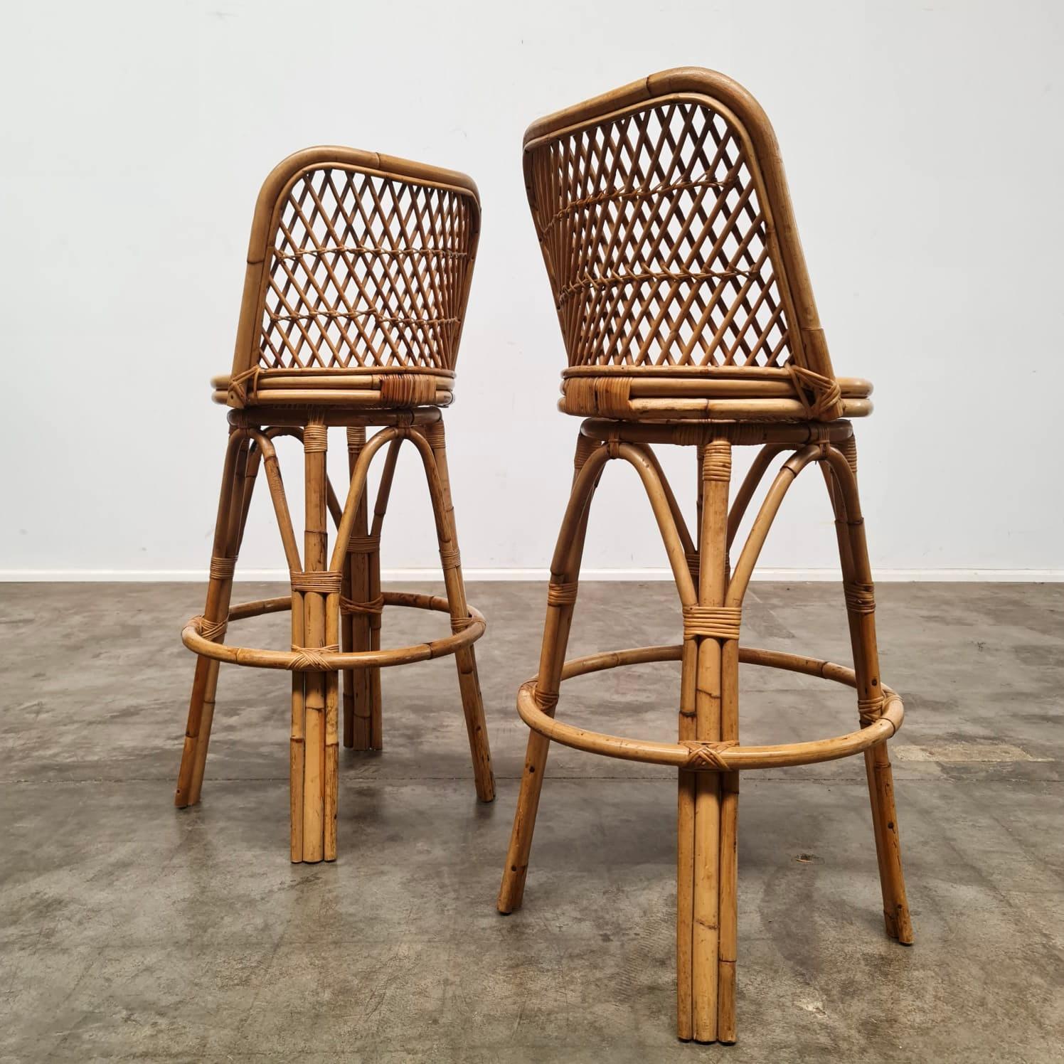 Set of two Bamboo and cane Barstools. Well crafted of bent bamboo with wrapped rattan around the joints. Displays a lovely hint of patina. Would look lovely in a beach house breakfast bar or in a tiki bar setting. These two stools have been freshly