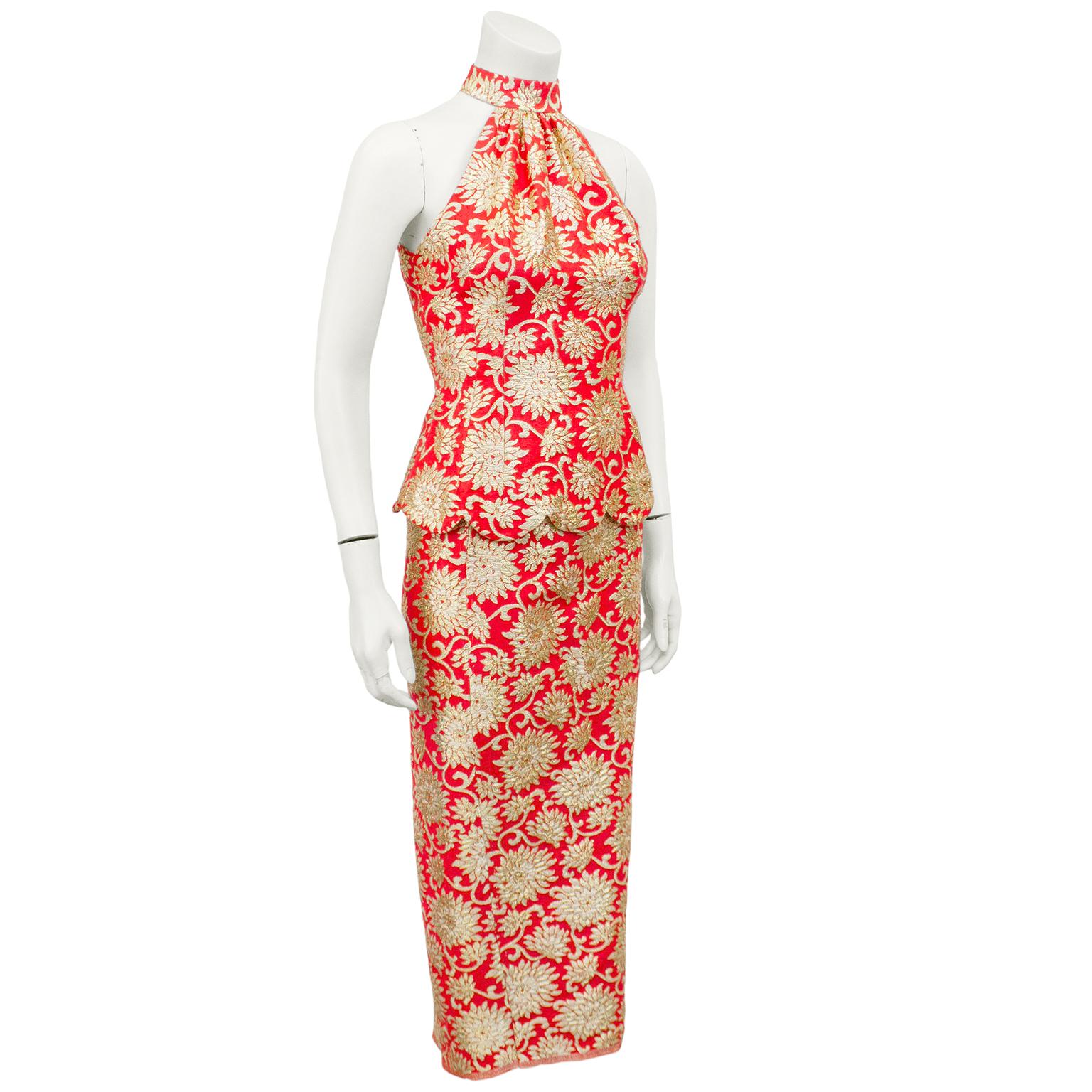 1960's bright coral and gold floral brocade top and skirt ensemble by Hawaiian designer Carla Dupréé. Fitted top features a halter neckline, scalloped hem and fabric covered button closures up centre back. Skirt is high waisted, pencil style, midi