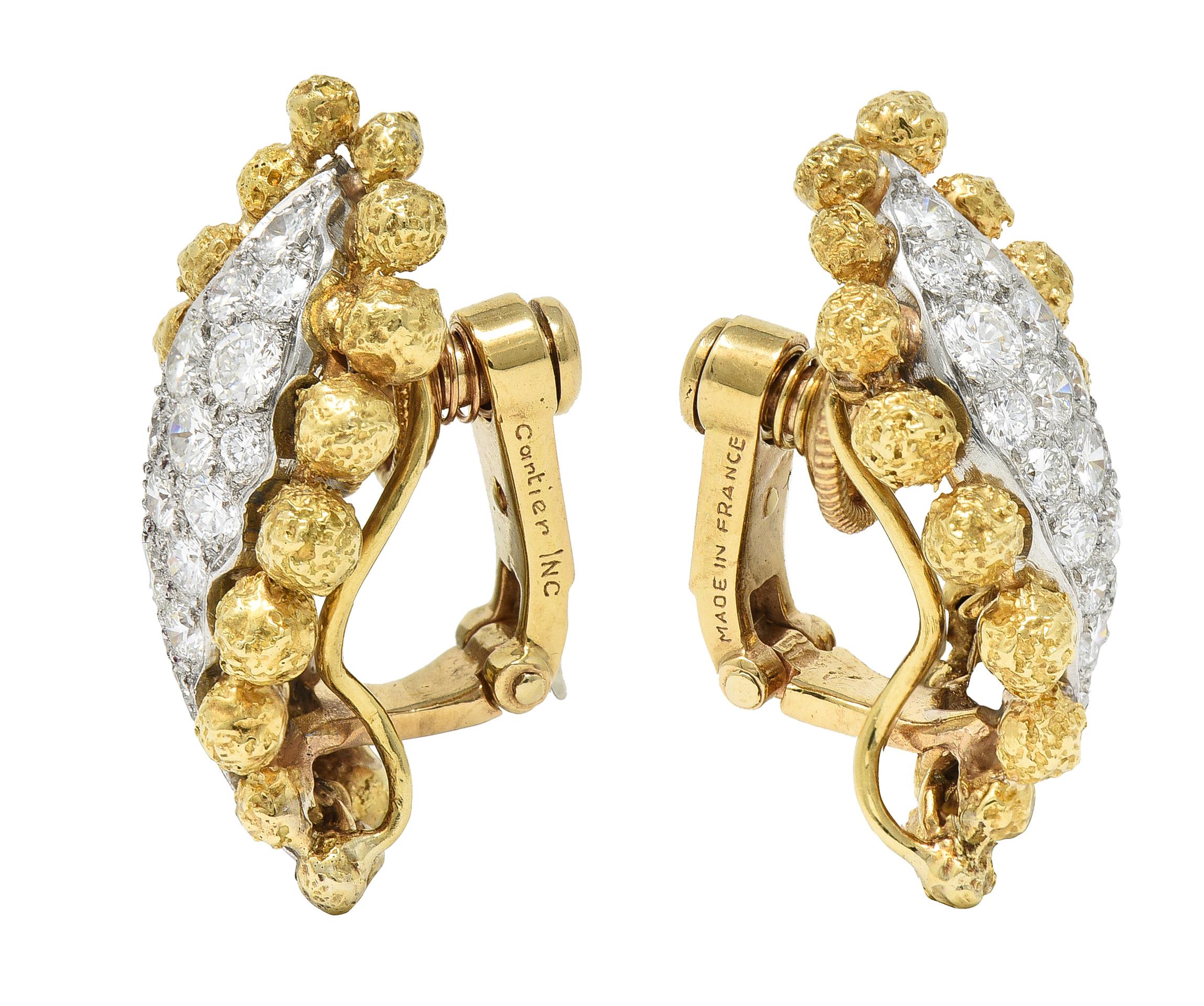 Ear-clips are designed as a slightly torqued platinum tendril with a textured gold ball surround. Platinum is pavè set with round brilliant cut diamonds. Total diamond weight is approximately 2.36 carats - F/G color and primarily VS clarity.