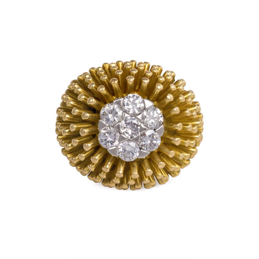 A gold and diamond cocktail ring of bombé anemone design with diamond cluster center and fluted shank, in 18k.  Cartier, France, #1-4719.  Atw seven diamonds 0.94 ct.  Accompanied by Cartier box and copy of statement from Cartier dated September 22,