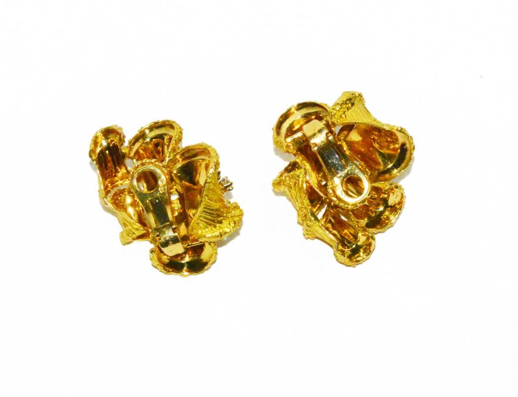 Gorgeous Cartier 18K yellow gold and diamond ear clips (a post can easily be added, if needed). Great day or night earring.  Classic and comfortable.