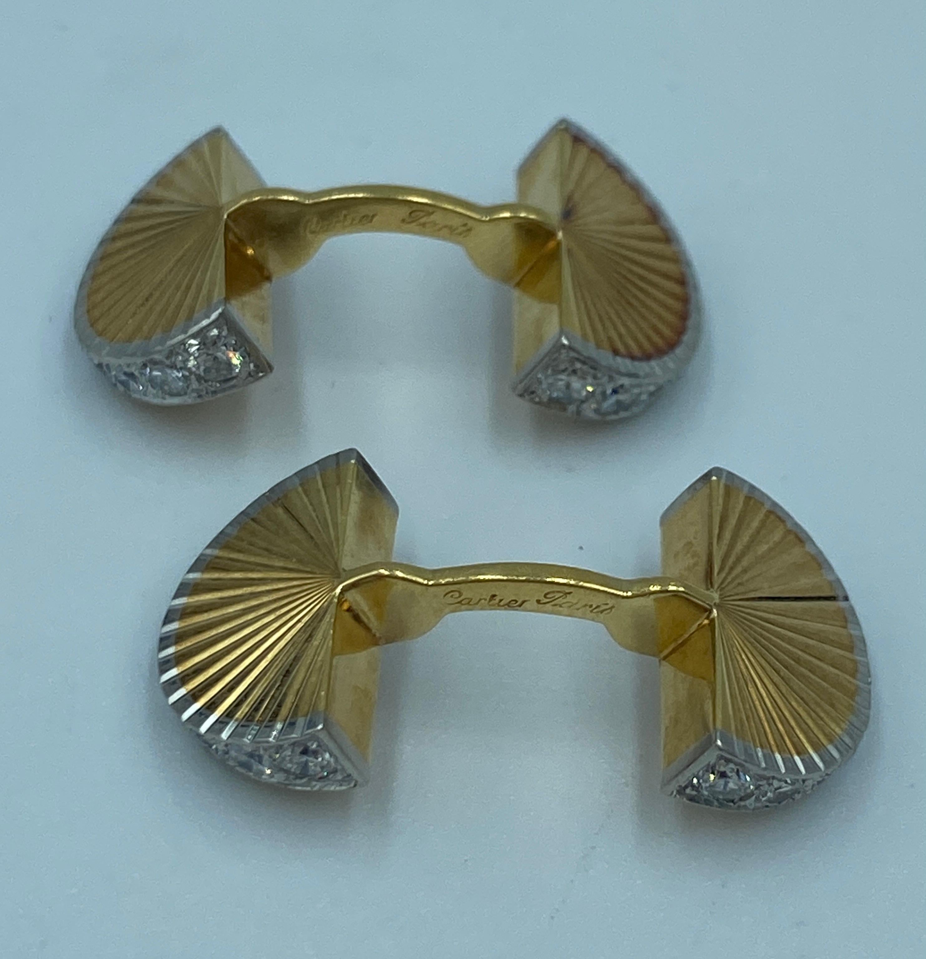 A stunning pair of solid double sided cufflinks in 18k gold both ends of which are adorned with round cut diamonds. The cufflinks are in the shape of 2 fans connected by a stiff bar. They are signed by Cartier of Paris and fitted in a Cartier box.