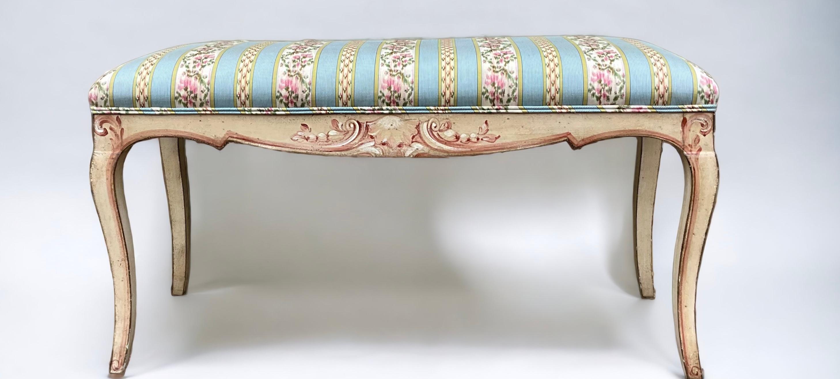 This is a sweet bench! It is an Italian piece with hand painted scrolling shells and vintage striped floral chintz cotton. It is in very good vintage condition and is unmarked.b