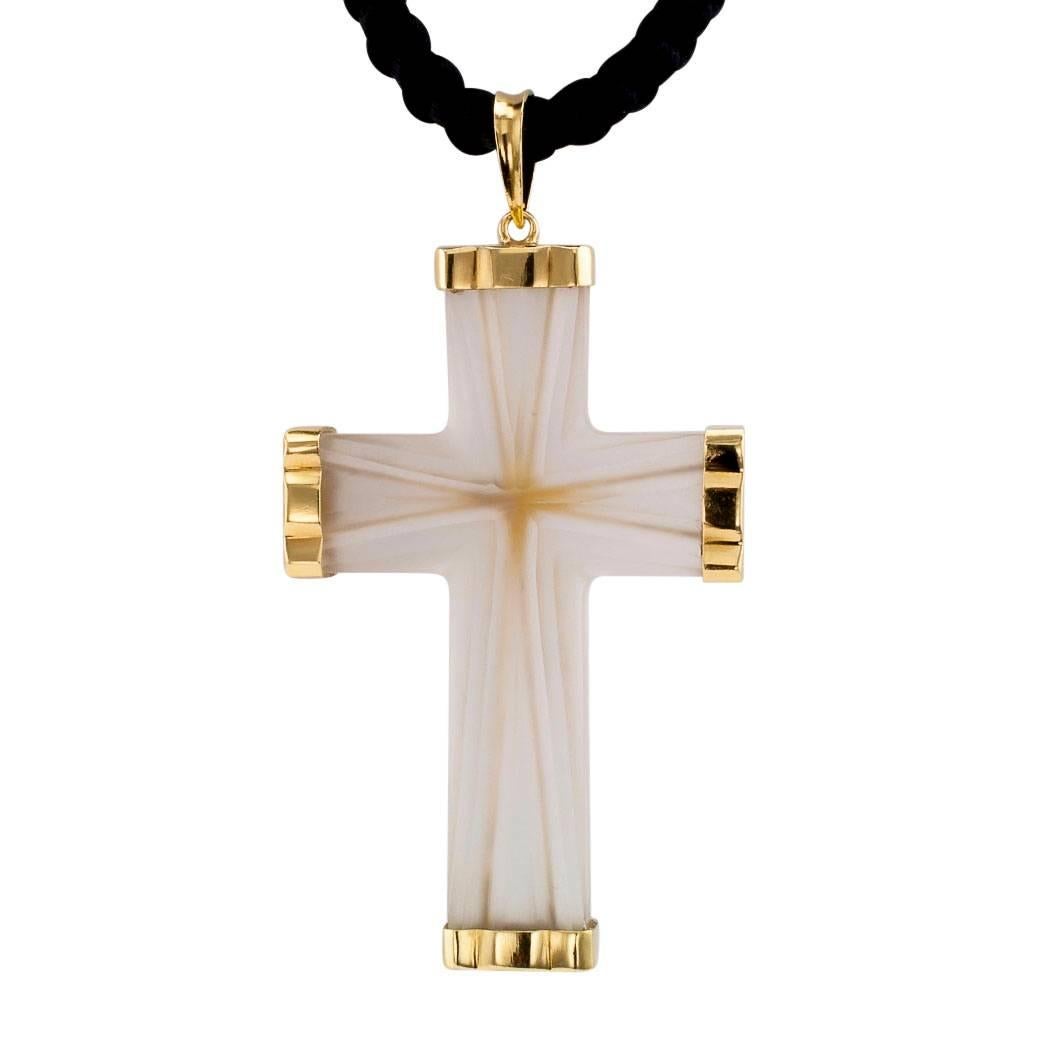 1960s rock crystal and gold reversible cruciform pendant. The large scale cross design is crafted in 18-karat yellow gold with carved and frosted rock crystal, featuring gold- capped arms with one side of the pendant fronting inlaid, bright