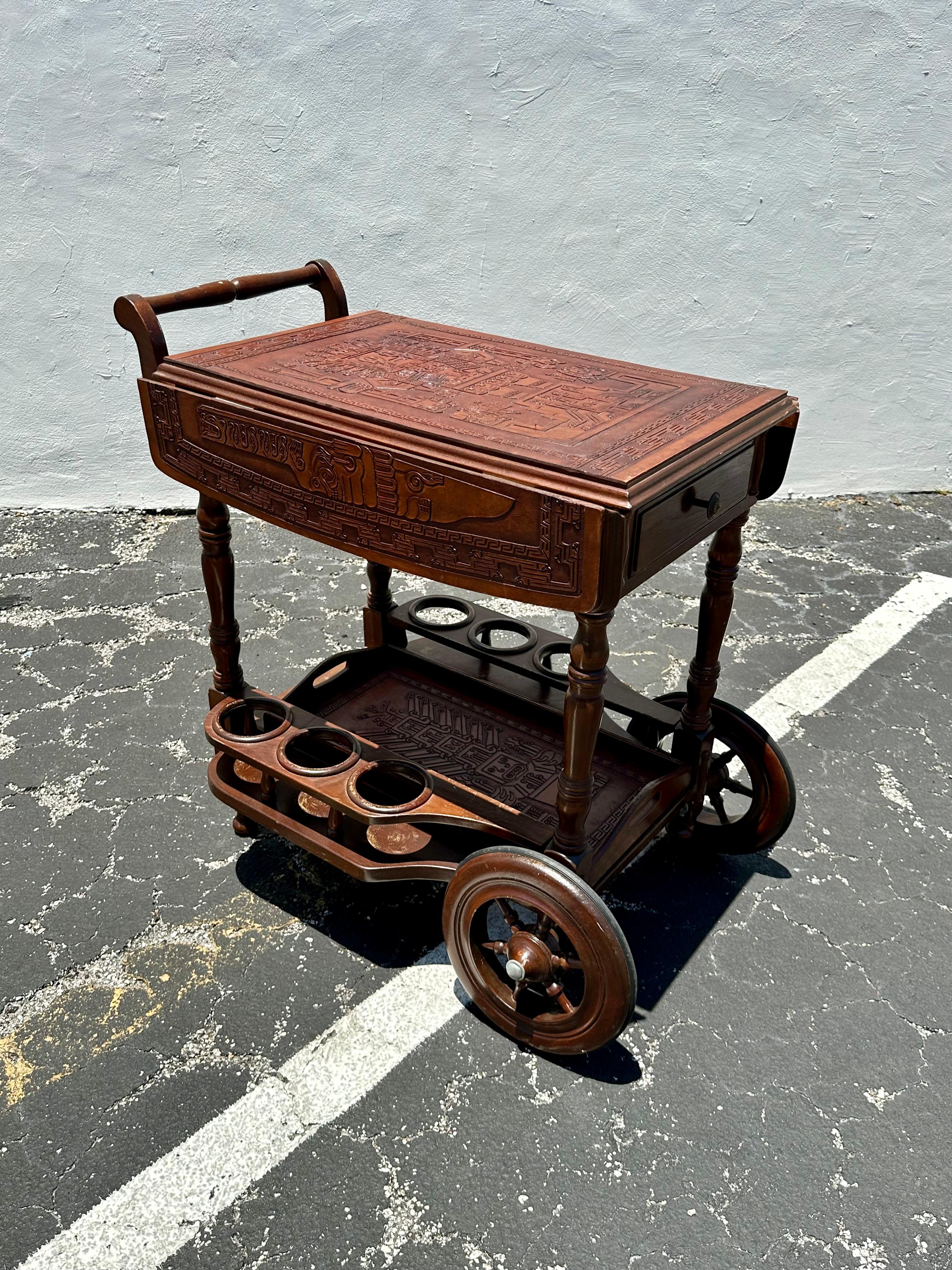 South American 1960s Carved Wood Leather Embossed Bar Cart Table For Sale