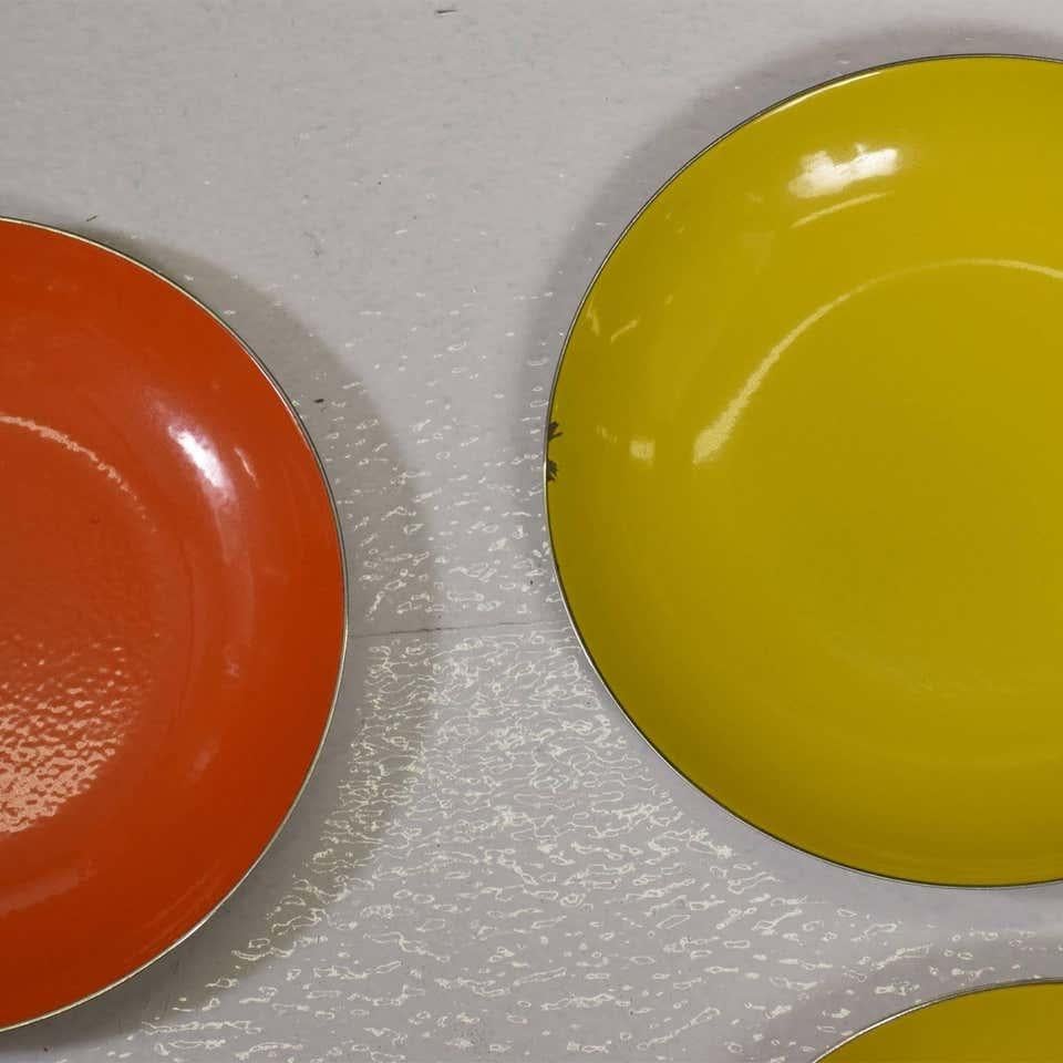 Cathrineholm of Norway set of 4 1960s modern vintage enamel and stainless steel plates in yellow and orange enamelware.
Three yellow plates and one orange plate.
Stamped by maker.
Dimensions: 7 1/2