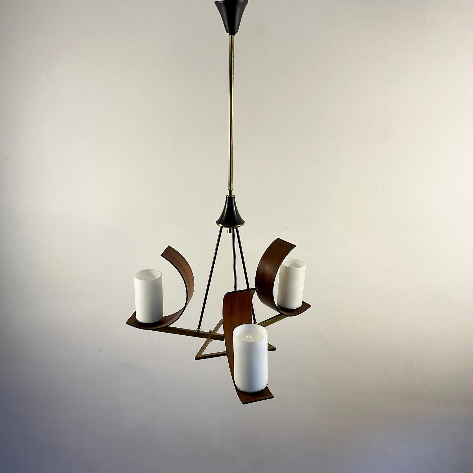 1960s three-armed brass pendant lamp attributed to the famous Italian lighting manufacturer Stilnovo.
Each carries three opal glass shades and is adorned with a teak wood semi-circle.