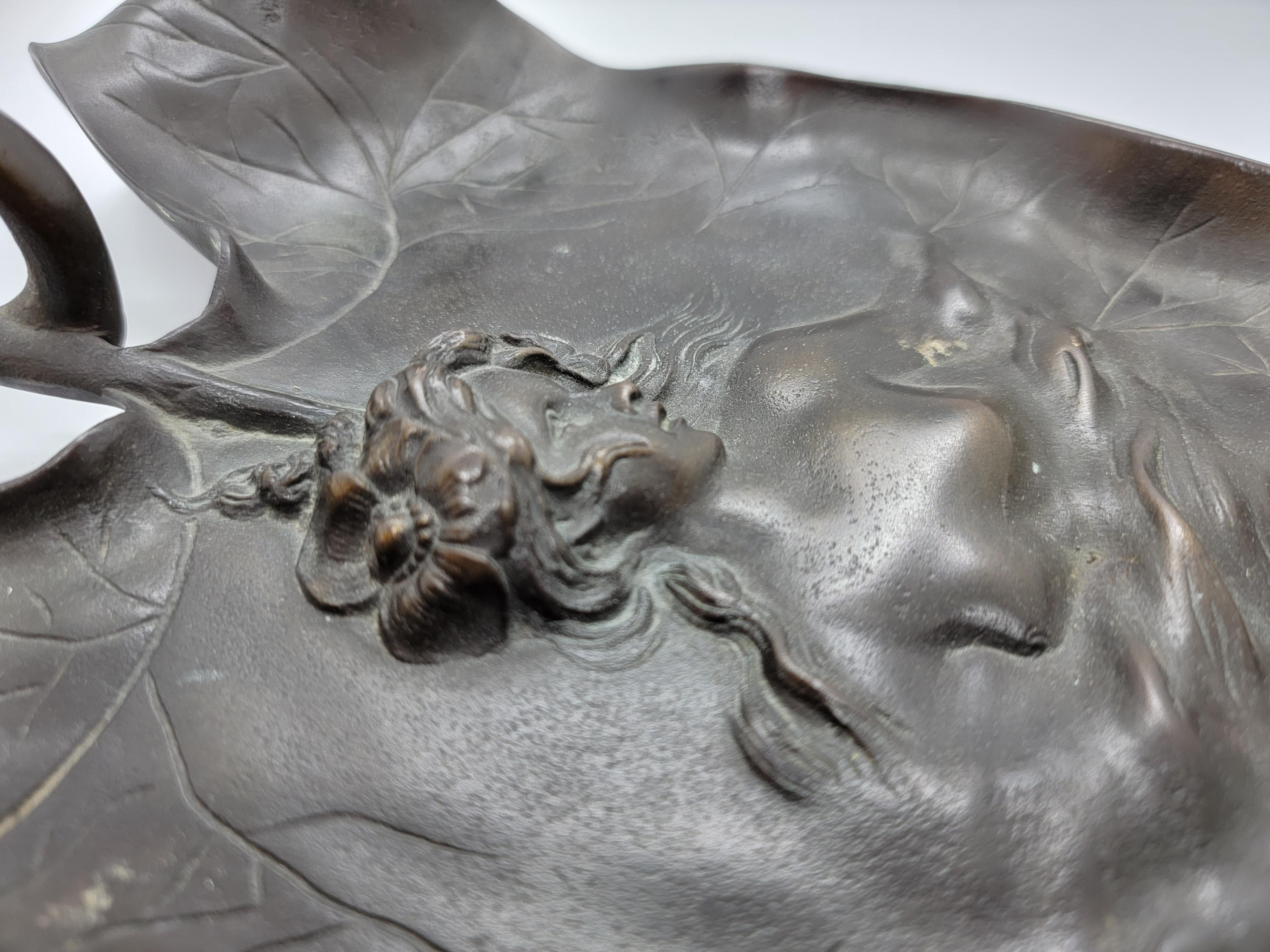 Pair of Decorative Leaf Molds W/Womans Figure. the upper body of a nude woman is show as the decorative center piece within this centerpiece/bowl very elegant and very sleek looking