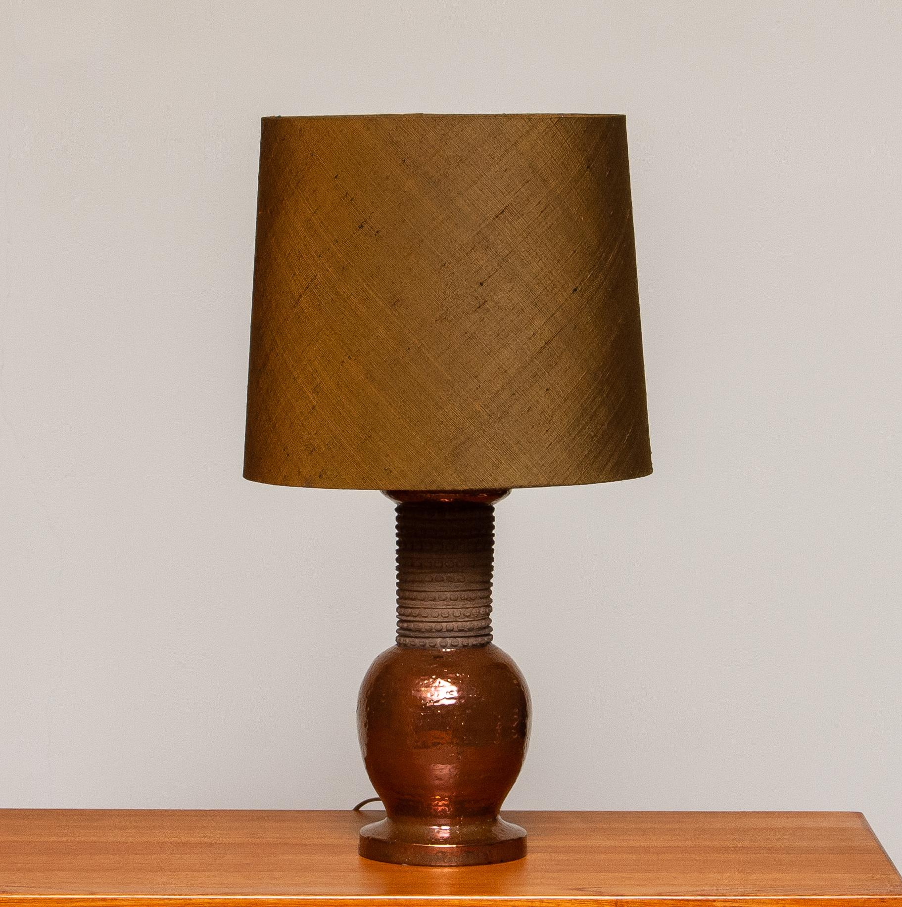 Beautiful with copper covered, ceramic table lamp made by Bitossi Italy in the 60's for Bergboms Sweden.
The lamp is in excellent condition and technically 100%. The fitting are for a screw bulb size E27 E28 and suit 110 and 230 volts.
The shade