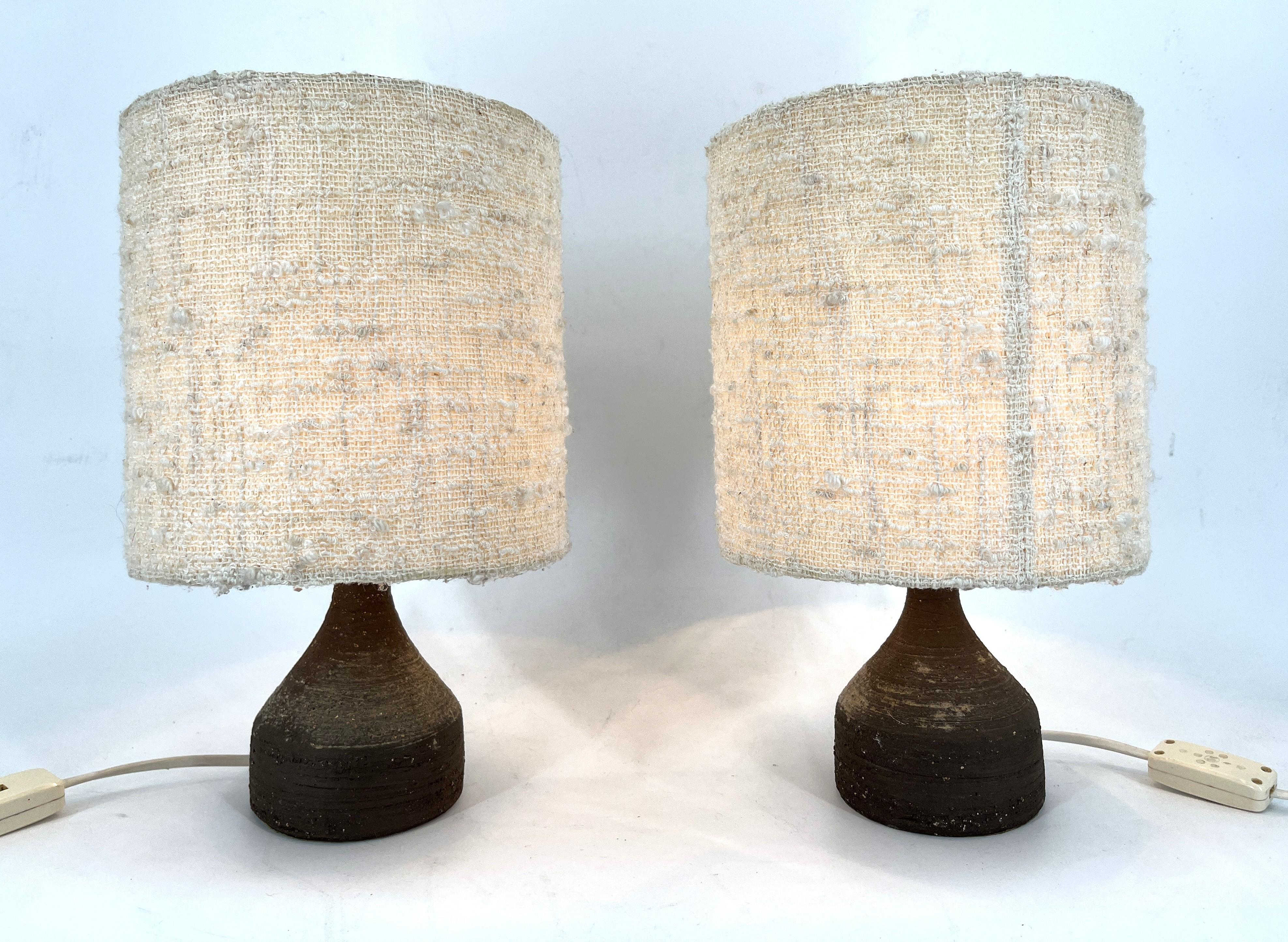 Pair of very decorative table lamp by Pottery Manufacturer Krösselbach.

The base are made of rough, unglazed dark brown ceramic manganese fireclay and they come with their original fabric lamp shades.

Both lamps are tested and work with regular