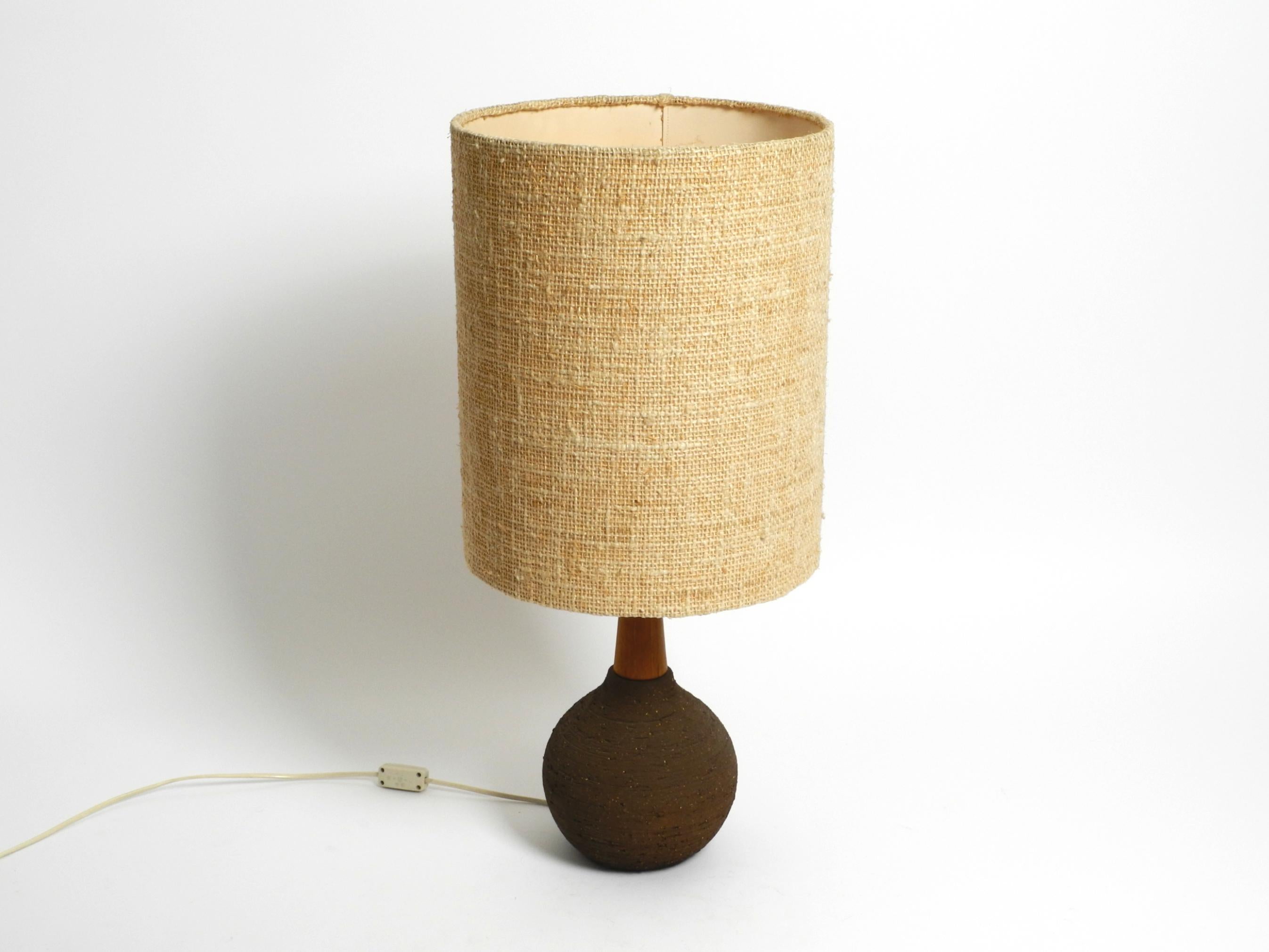 Very beautiful 1960s German ceramic table or floor lamp with a large original fabric shade by the world-famous Krösselbach ceramic manufacturer. Made in Germany. With a label on the underside.
Heavy, artistic, rough, unglazed base made of dark brown