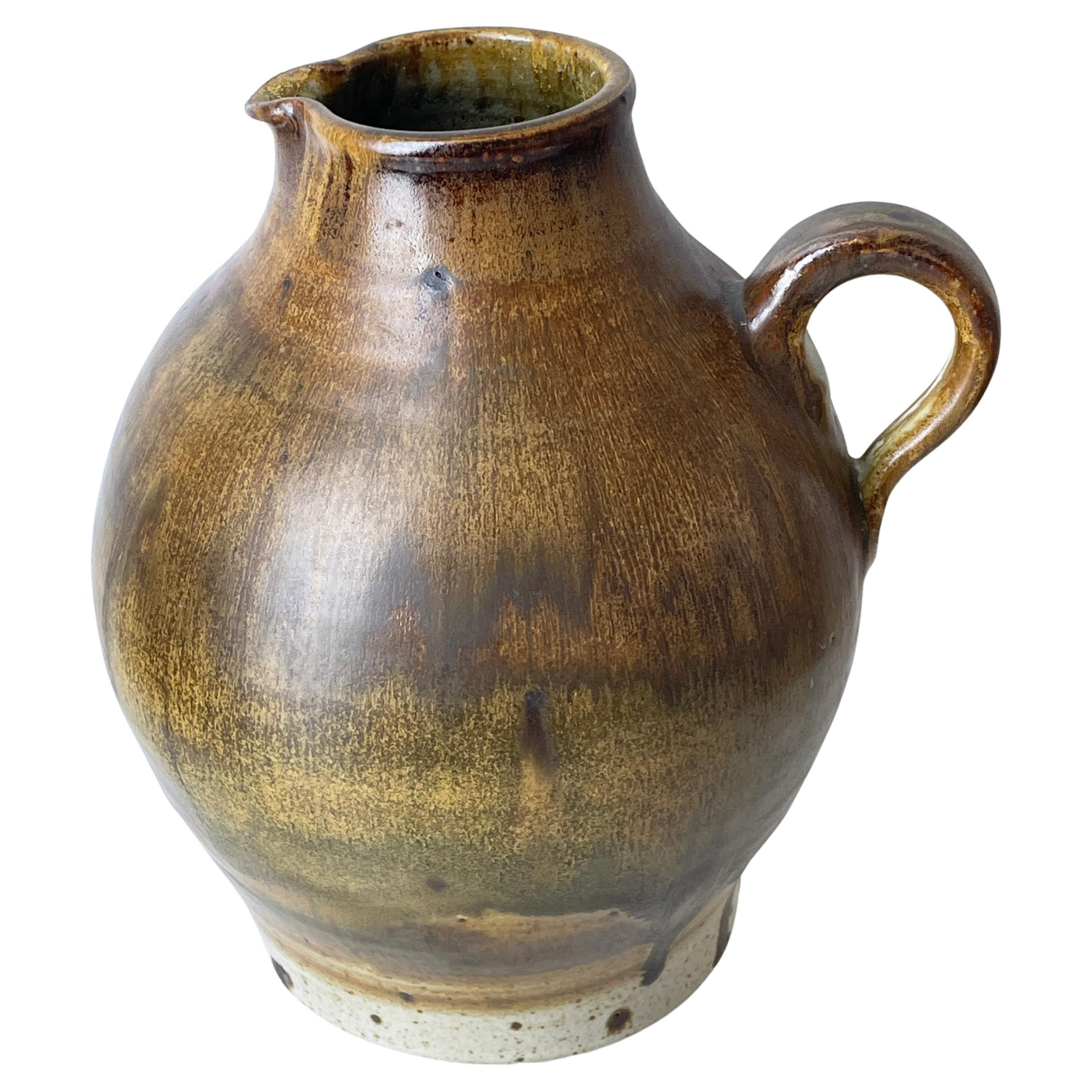 1960's Arnold Zahner hand made ceramic vase by Rheinfelden Keramik, Switzerland.
Studio name on Base: Rheinfelden. 
Lovely brown & ochre drip glaze. Beautiful example of Swiss mid century ceramics by a renowned Swiss ceramicist, Arnold Zahner.
In