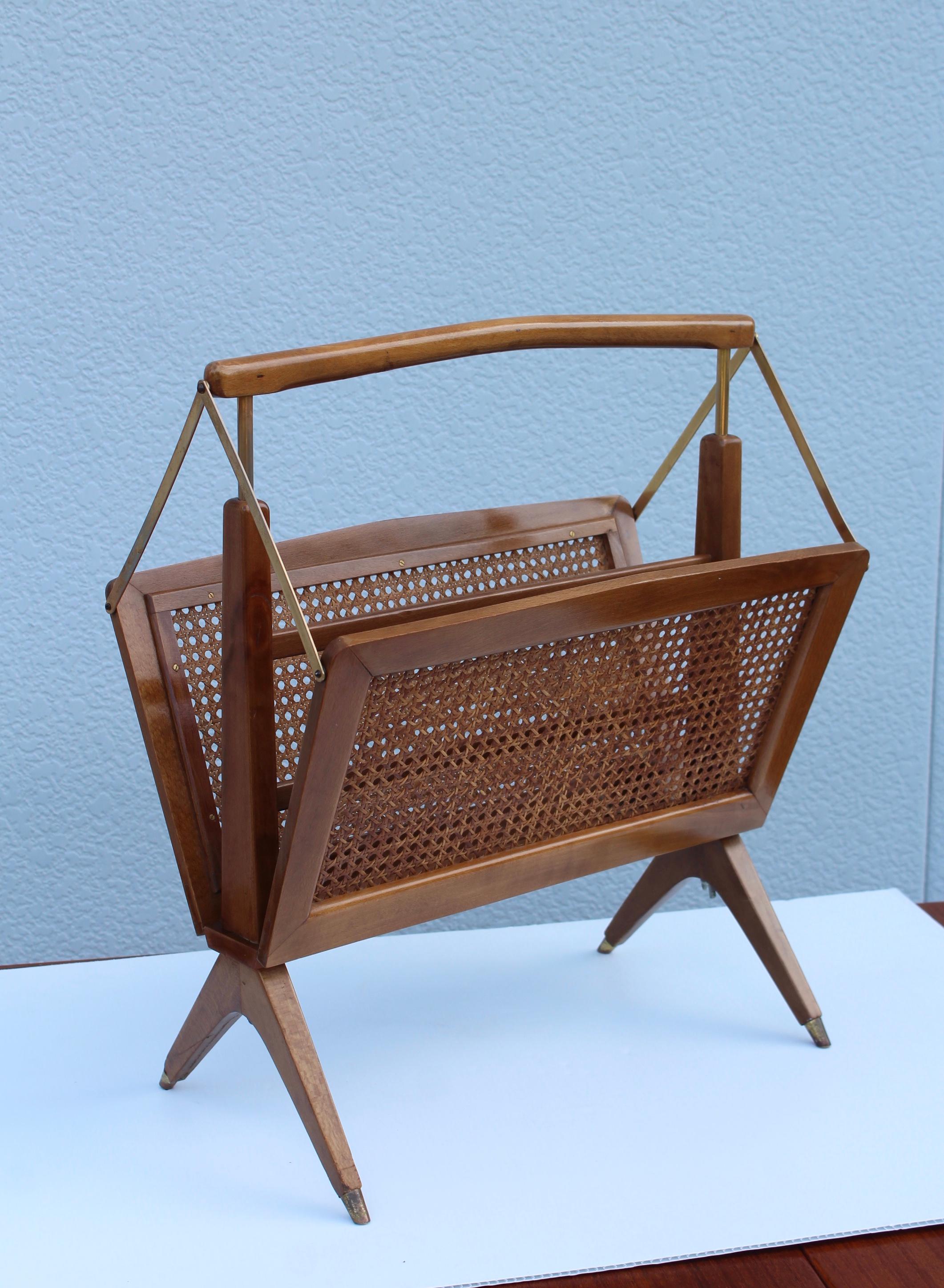 1960s modern folding Italian magazine holder by Cesare Lacca. made of walnut and rattan with brass hardware.