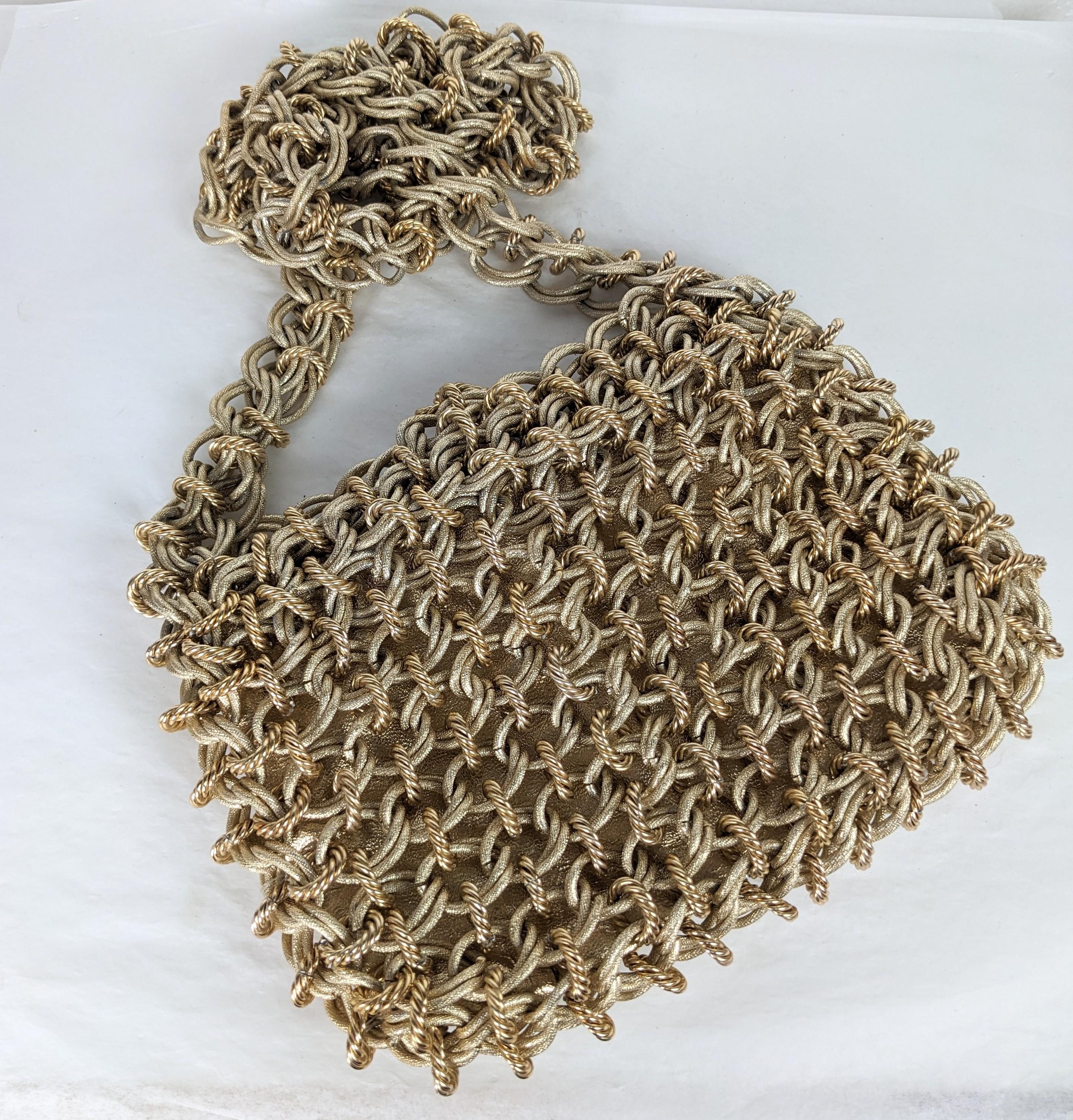 1960's Chain Gilt Chainmail Mesh Shoulder Bag by Raoul Calabro. Hand linked 2 toned gold textured chain link with metallic gold leatherette liner. Long shoulder strap for shoulder or crossbody wear and chain toggle closure. Raul Calabro label,