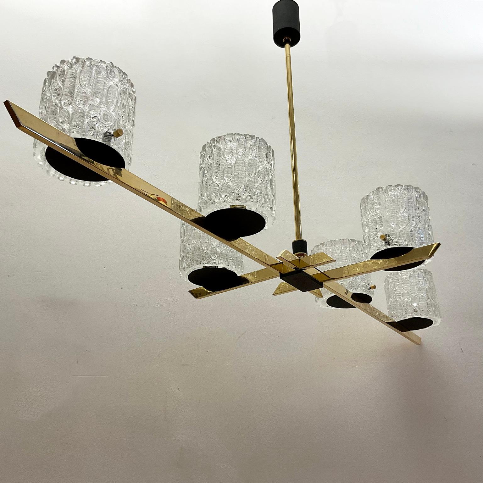 Maison Arlus chandelier from the 1960s with a brass finish frame that supports six glass-molded shades.
Rewired in a way with the possibility of four or six lamps on.