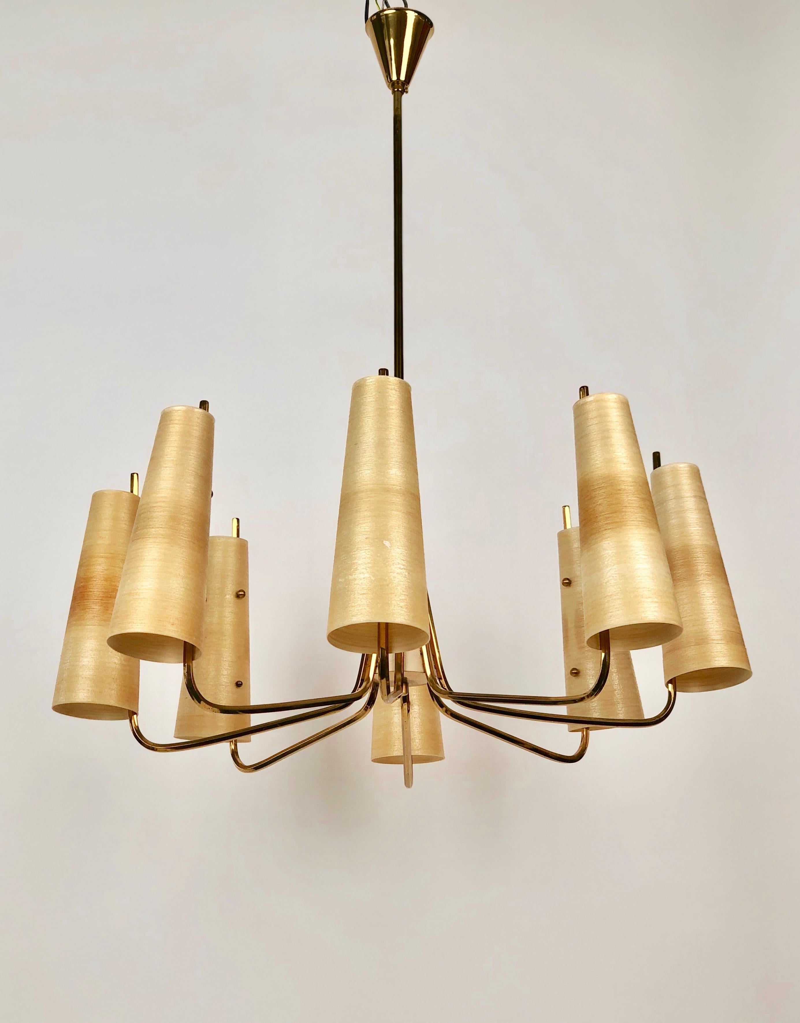 Mid-century chandelier with eight arms in brass. The arms are made from hexagonal
tubbing giving the chandelier a unique character . Eight fibreglass shades compliment
the form .

