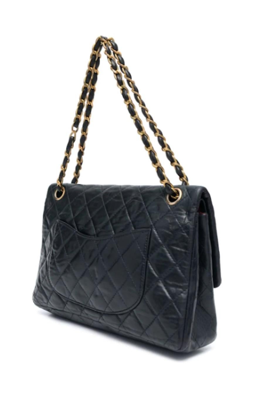Chanel by Coco Chanel navy shoulder bag 2.55 from 1960s  featuring iconic quilted leather, gold tone hardware with front closure, the iconic signature gold-tone metal and leather interwoven shoulder strap, inside double flap iconic detail, inside