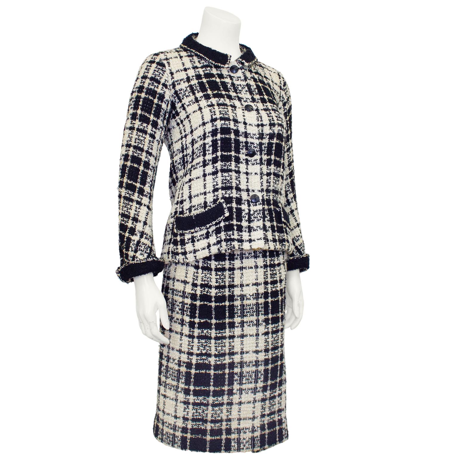 Stunning Chanel Haute Couture black, cream and gold plaid tweed jacket and dress ensemble from the 1960s. The jackets features a Peter Pan collar with pointed black resin buttons, folded slit pockets at the hips and turned cuffs that are tacked in
