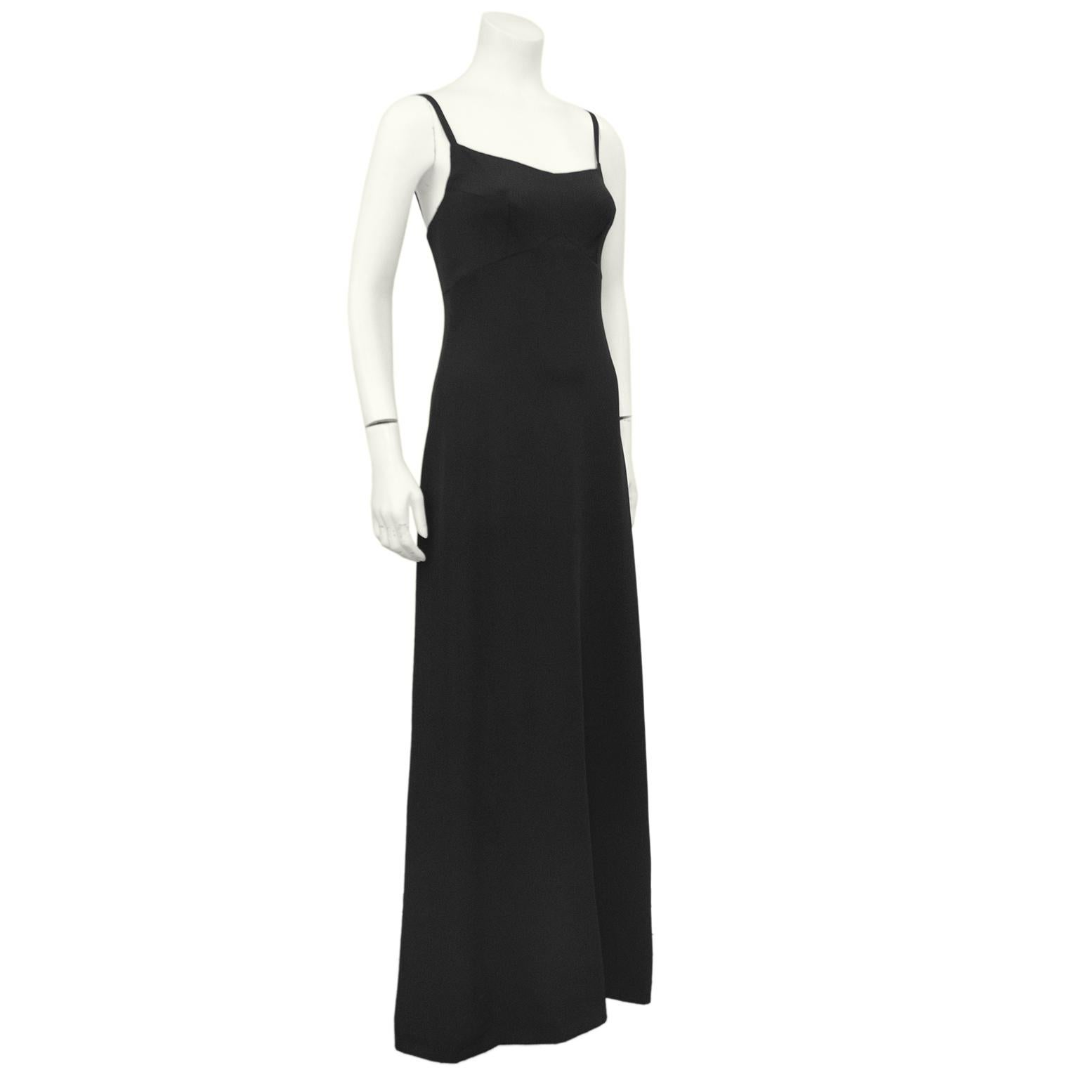 Simple, elegant and timeless. This minimalist Chanel Haute Couture gown from the 1960s is truly breathtaking. Cut from luscious thick black silk, this gown features 1/2