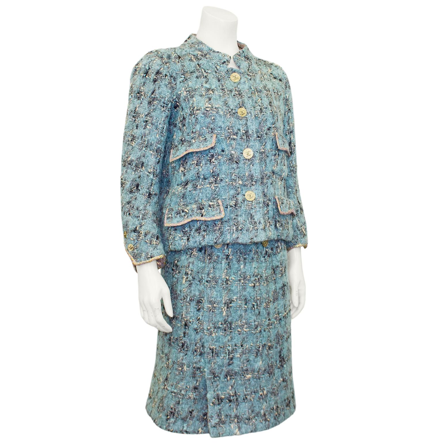 Chanel Haute Couture tweed and silk and lurex dress and jacket ensemble from the 1960s. The ensemble combines blue, black and cream tweed with a pink, blue and metallic silk and lurex lining. The jacket features a Mandarin collar, large gold tone