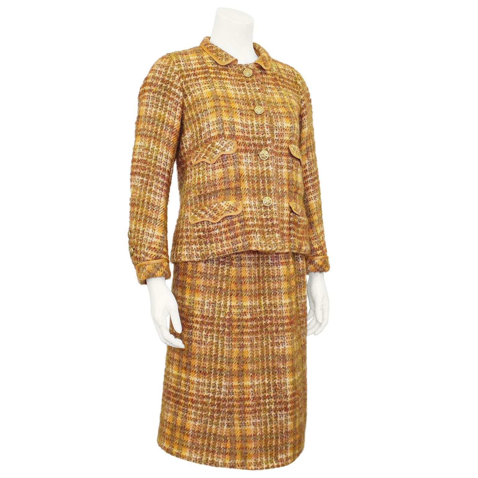 Chanel Haute Couture jacket and dress ensemble from the 1960s. A beautiful combination of tweed in shades of copper and copper coloured silk. The jacket features a small Peter Pan collar, stunning gold tone metal buttons with flower details, four