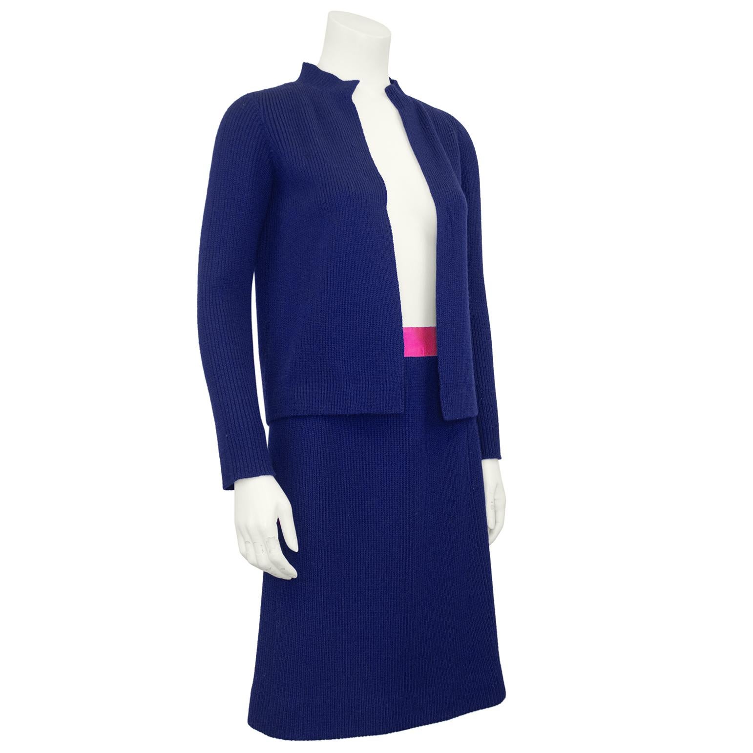 Unique vintage Chanel Haute Couture navy blue wool ribbed knit cardigan and skirt set. Very simple, high neck cardigan that sits open. The interior hem of the cardigan has a navy blue grosgrain ribbon trim to add some weight, so it hangs just right.