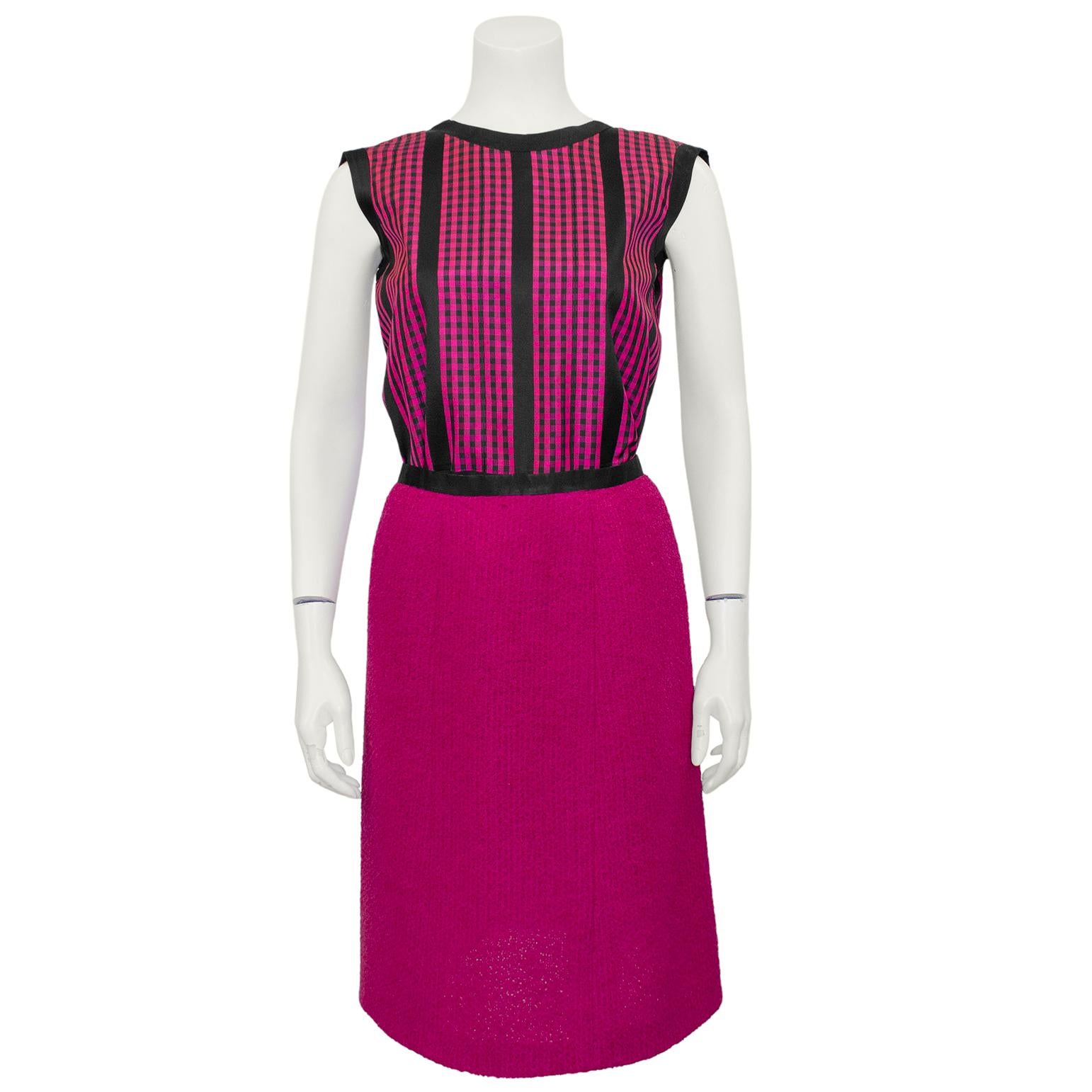 Dating from the 1960s, this three piece Chanel Haute Couture raspberry pink and black ensemble is pure perfection. The pink wool jacket is collarless with rounded edges and black silk trim. The chevron details on the patch pockets are very unique