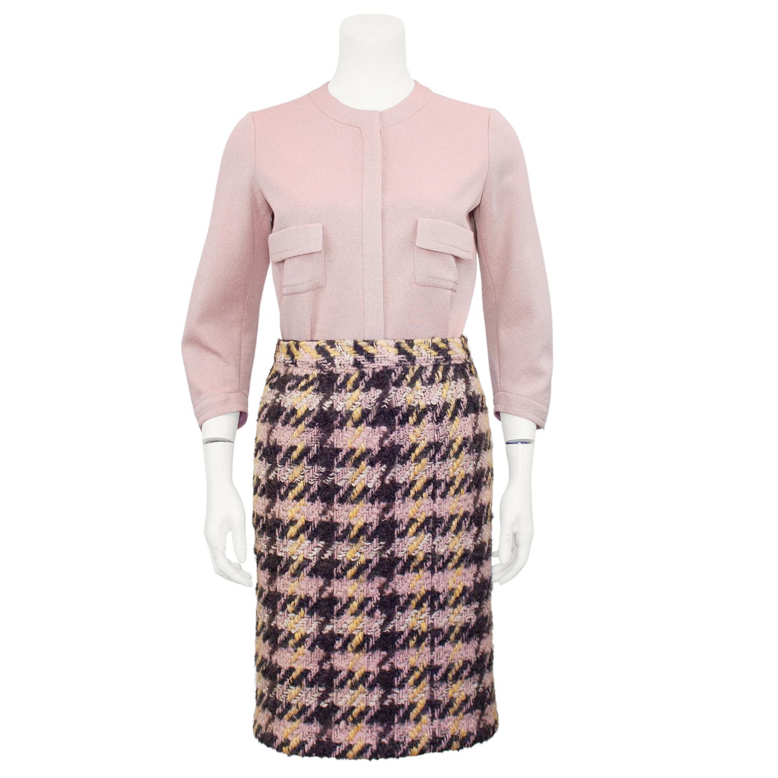 Very smart Chanel Haute Couture pink and charcoal grey houndstooth tweed ensemble from the 1960s. The 7/8 length jacket features pink and black buttons with gold tone metal lions head centre details and bracelet length sleeves. Thick cotton jersey,