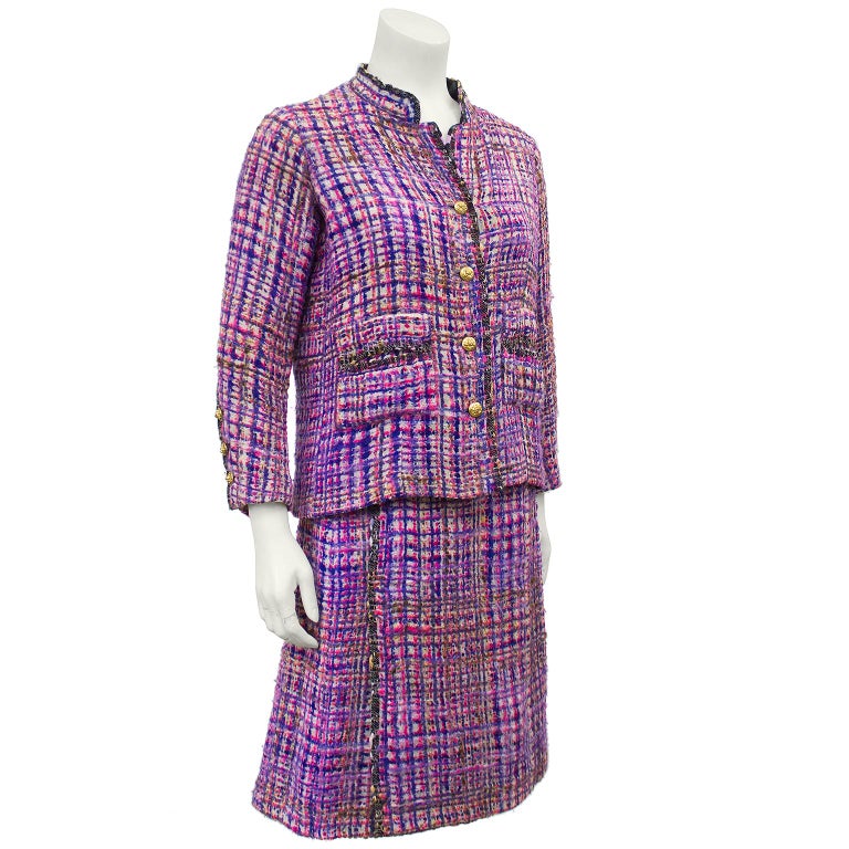 Chanel Haute Couture boucle suit from the 1960s. Label and style number have been removed. The jacket has a dark boucle trim that is woven into the purple and pink boucle fabric along the collar, front placket, pockets and cuffs. Entirely hand sewn,