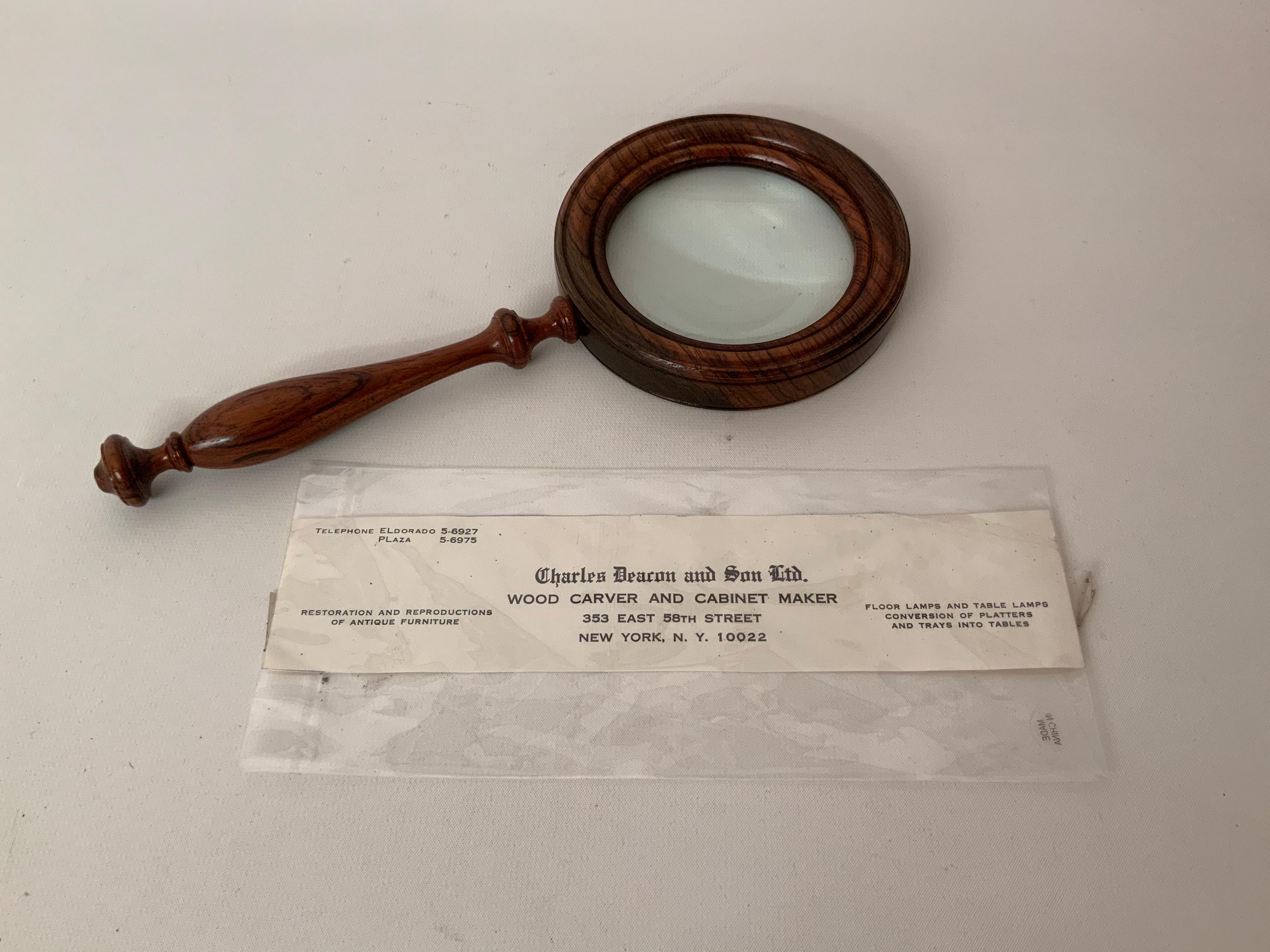 The solid rosewood magnifying glass is straight from the workshop of Charles Deacon and Son, 353 East 58th Street, NYC, circa late 1960s. Very good condition. No visible scratches on the lens.

Approximately 10
